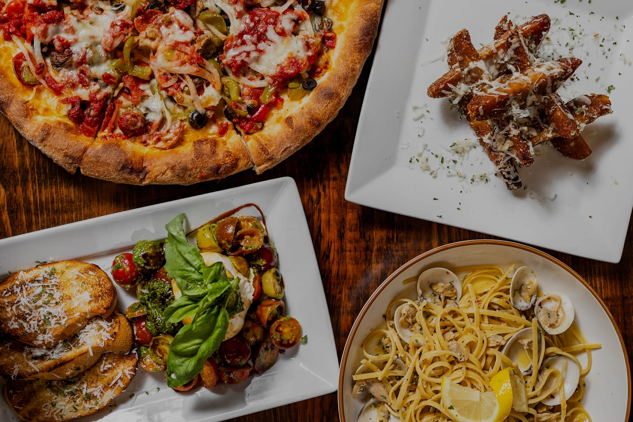 A variety of Italian dishes including pizza, pasta, and appetizers.