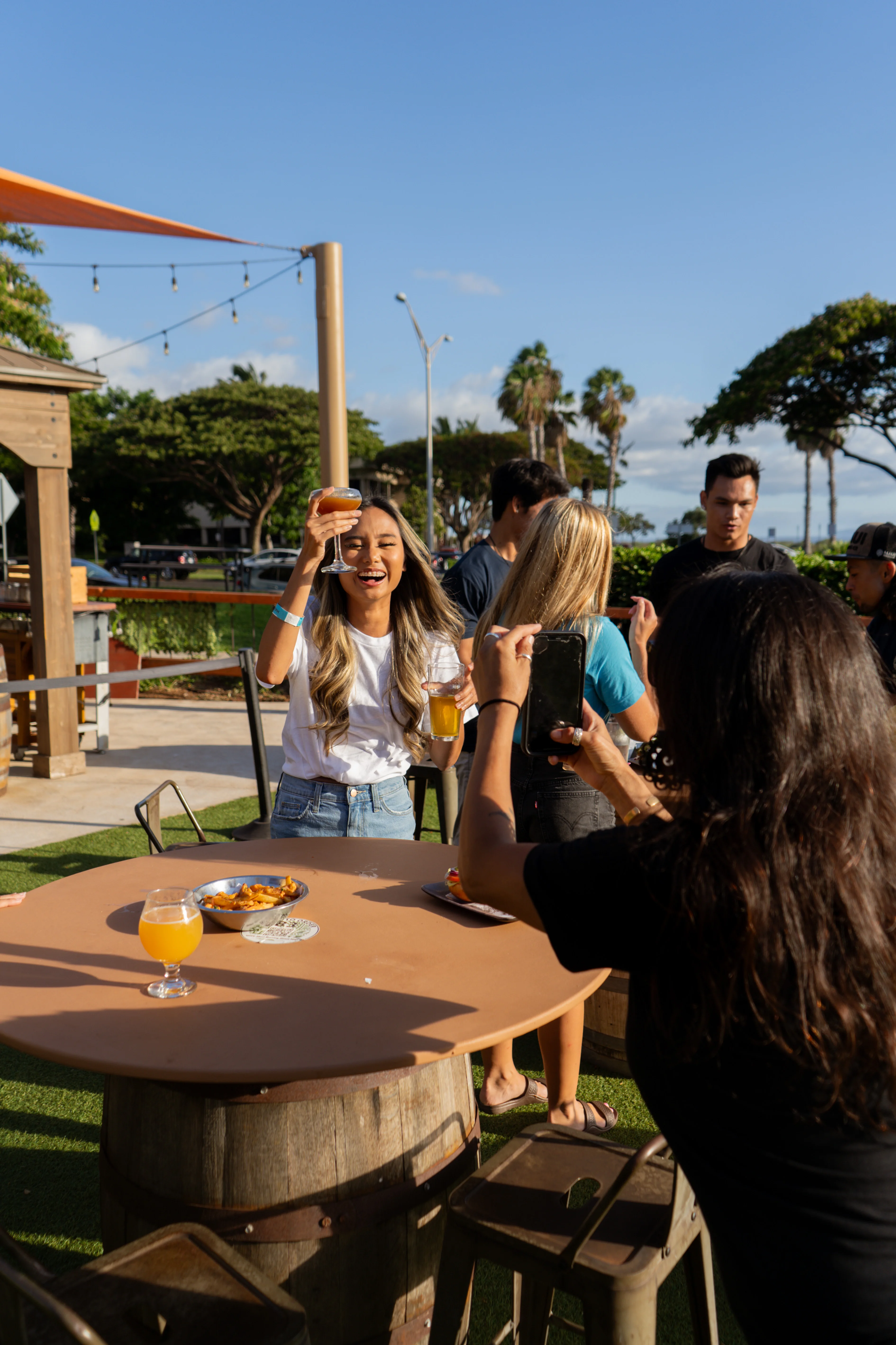 Group of friends enjoying drinks at a lively outdoor bar