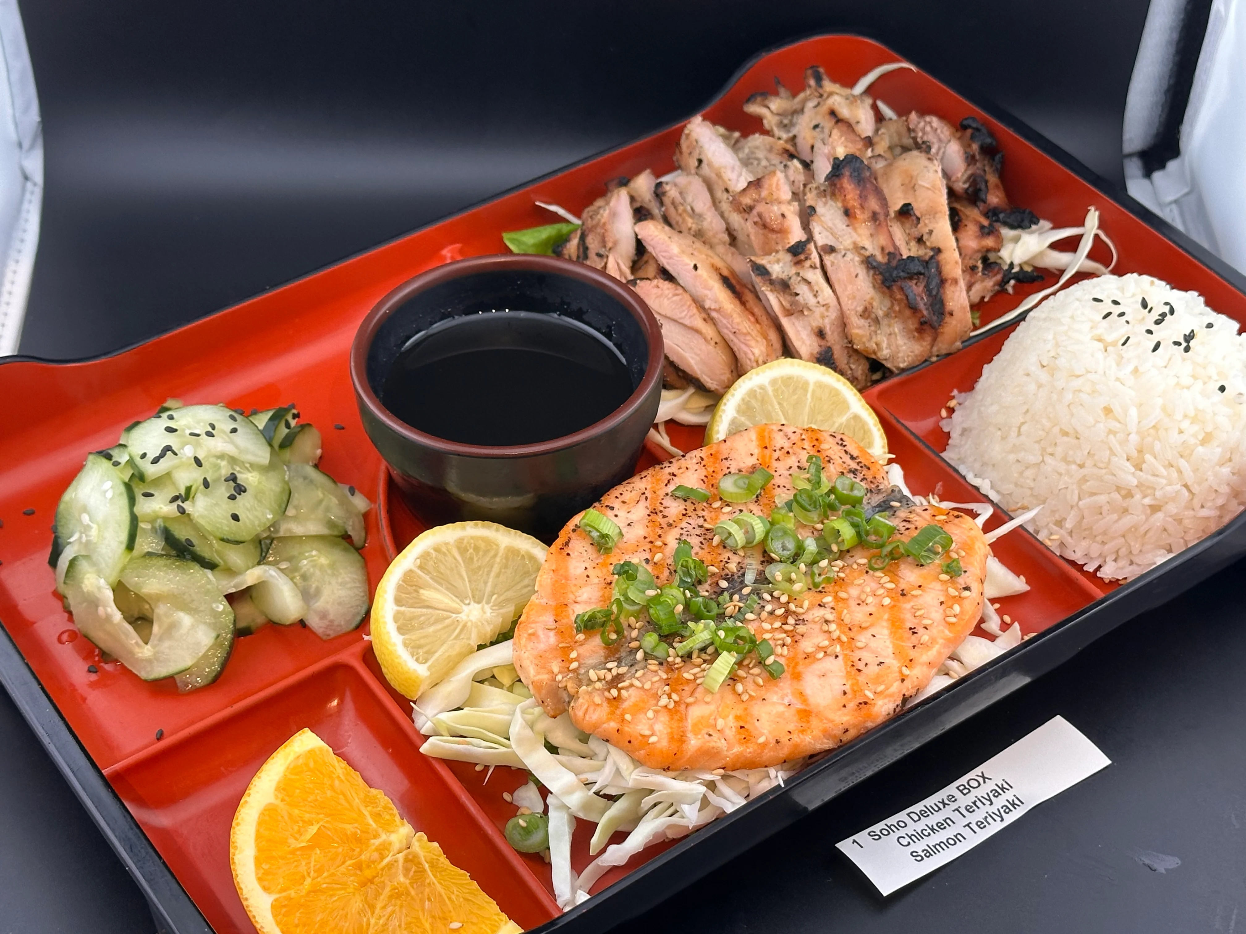 Japanese bento box with chicken teriyaki and salmon teriyaki