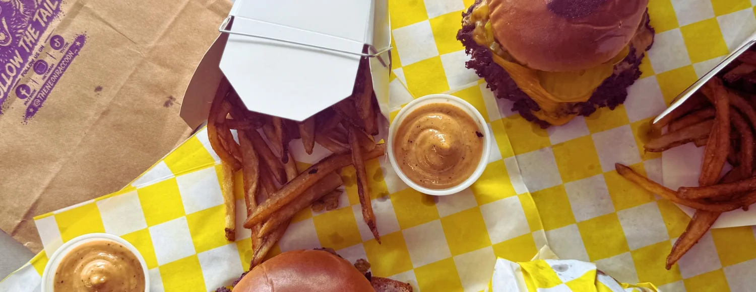 Juicy cheeseburger with fries and dipping sauce
