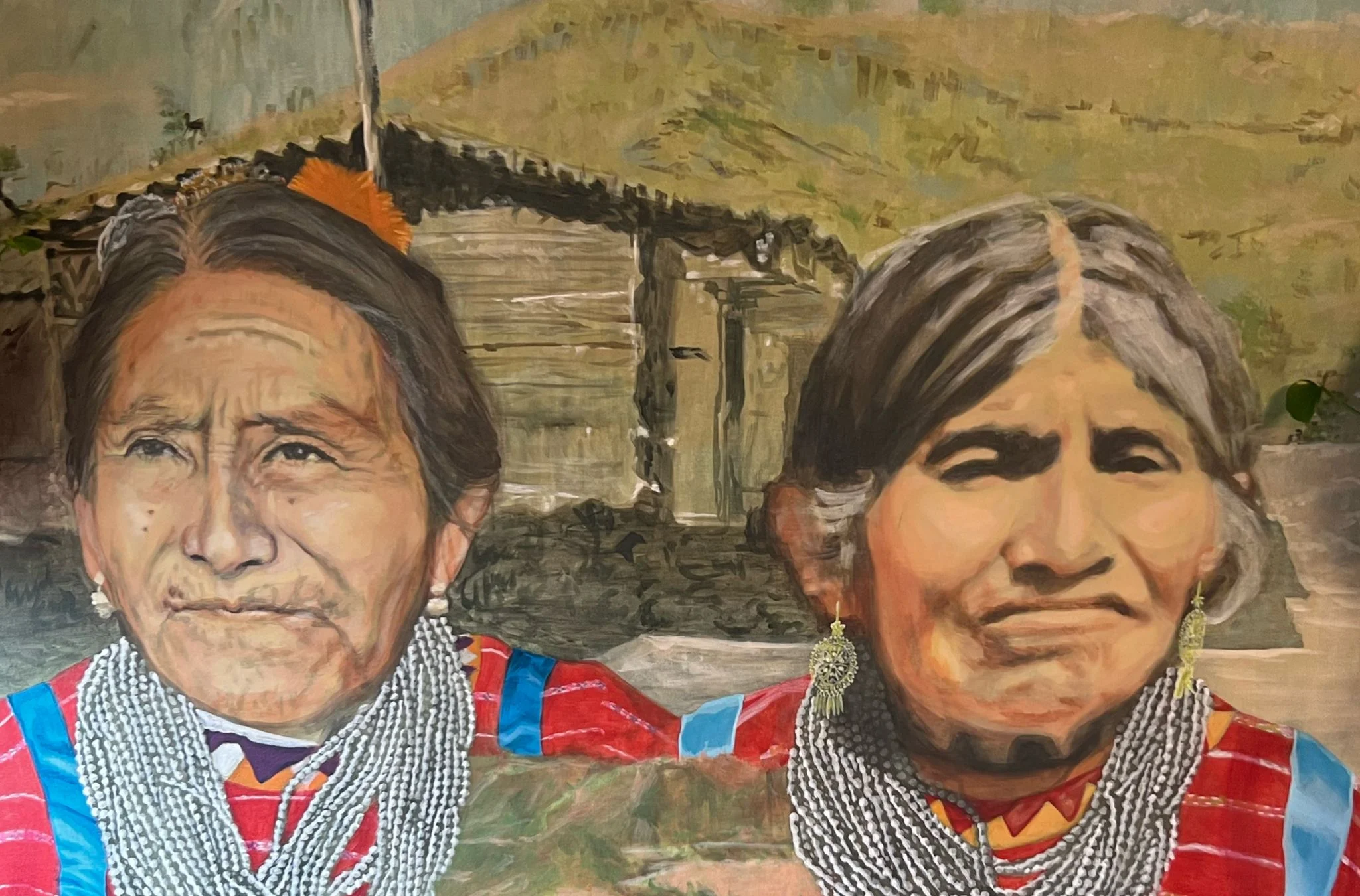 Portrait of indigenous woman in traditional attire with landscape background