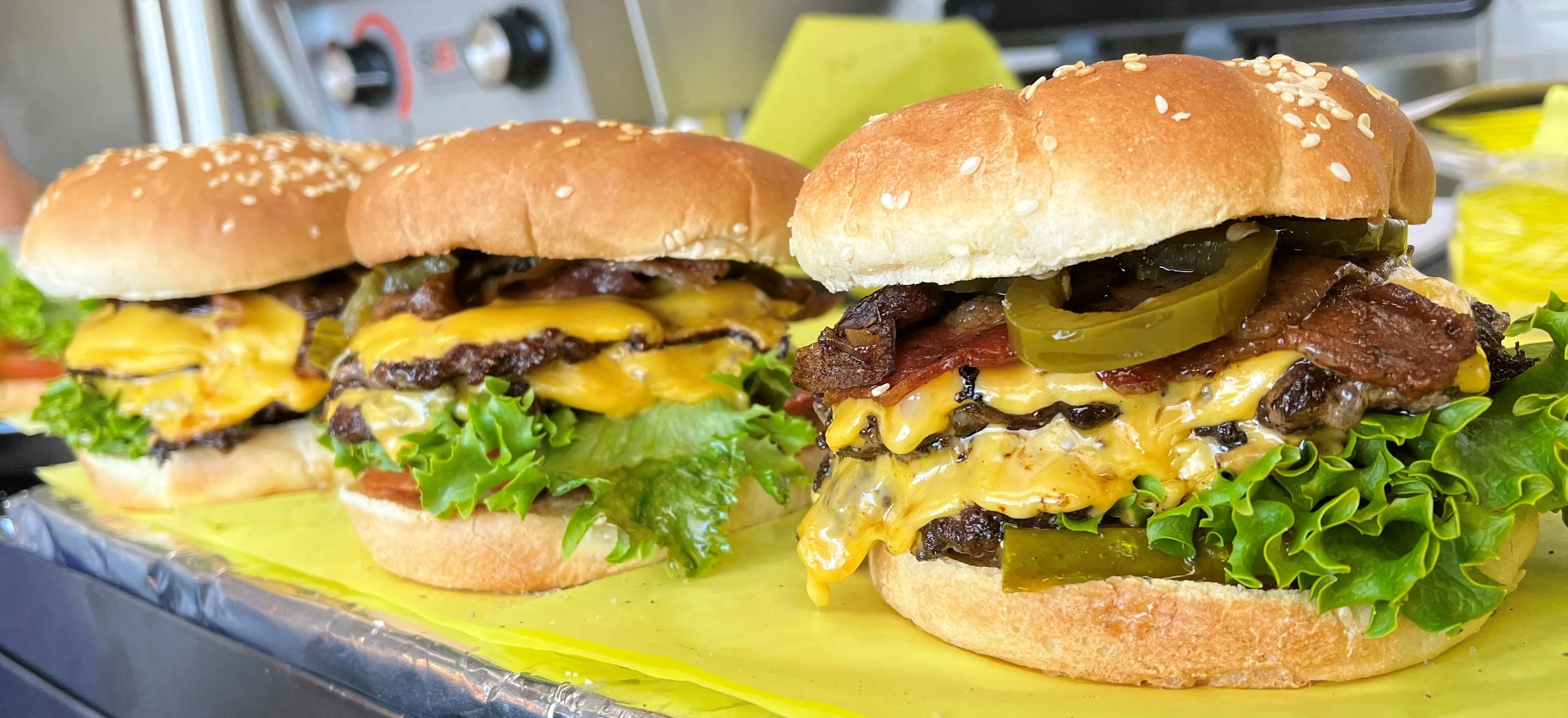 Juicy cheeseburgers with lettuce and pickles