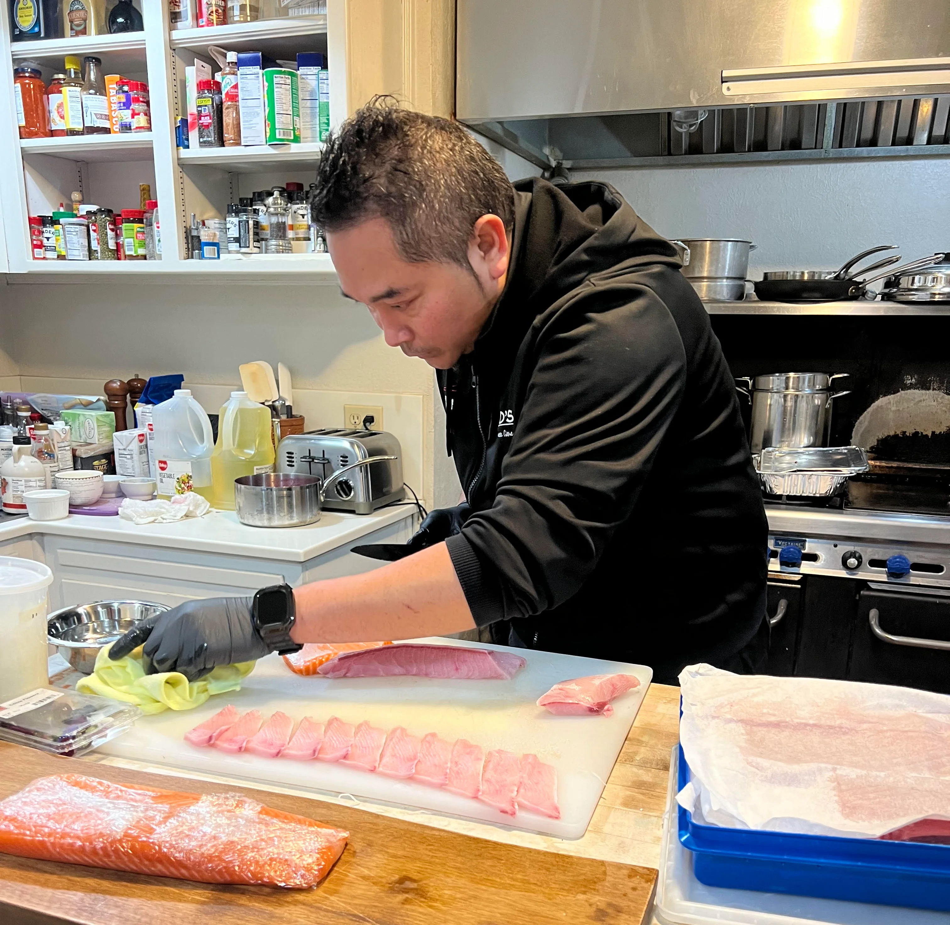Chef preparing sushi with fresh fish in a modern kitchen