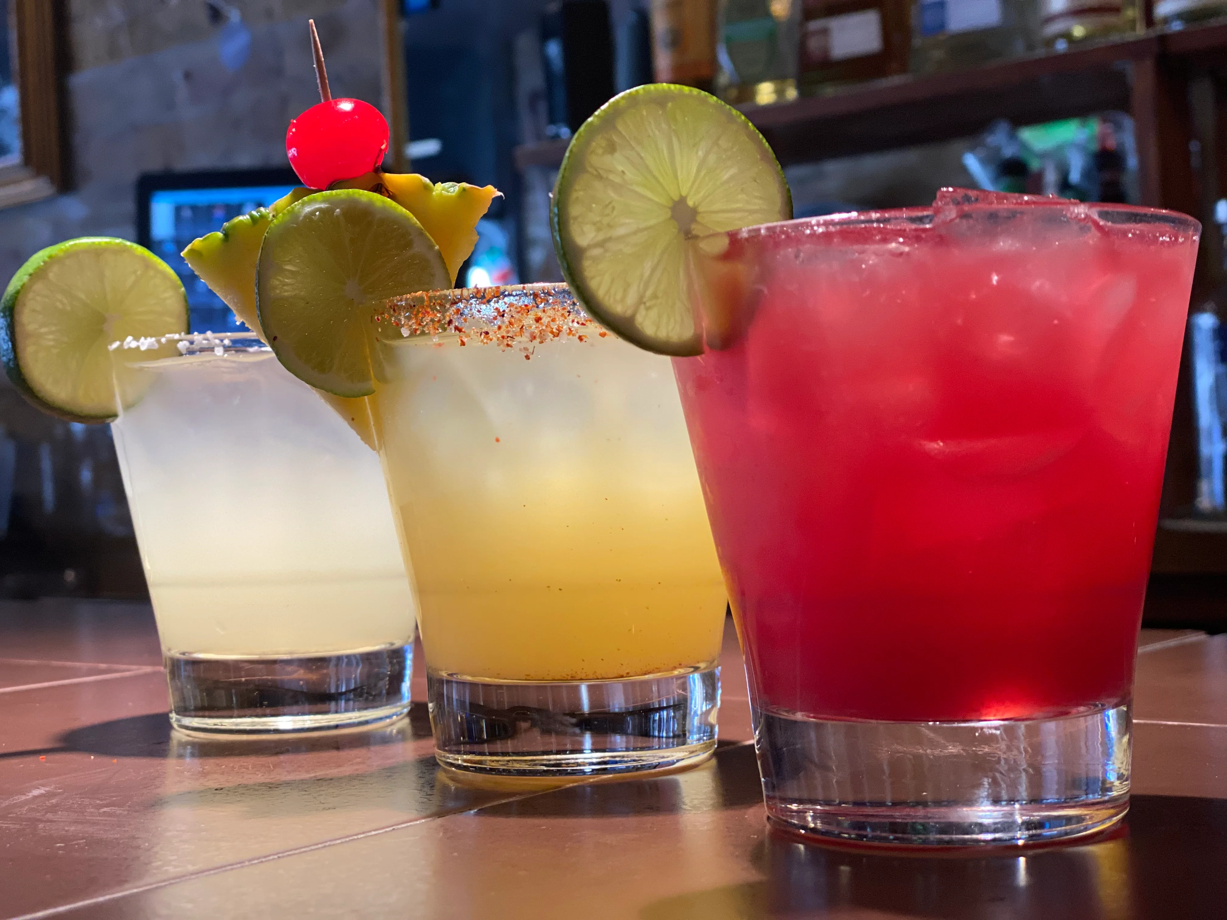 Colorful cocktails at a vibrant bar counter