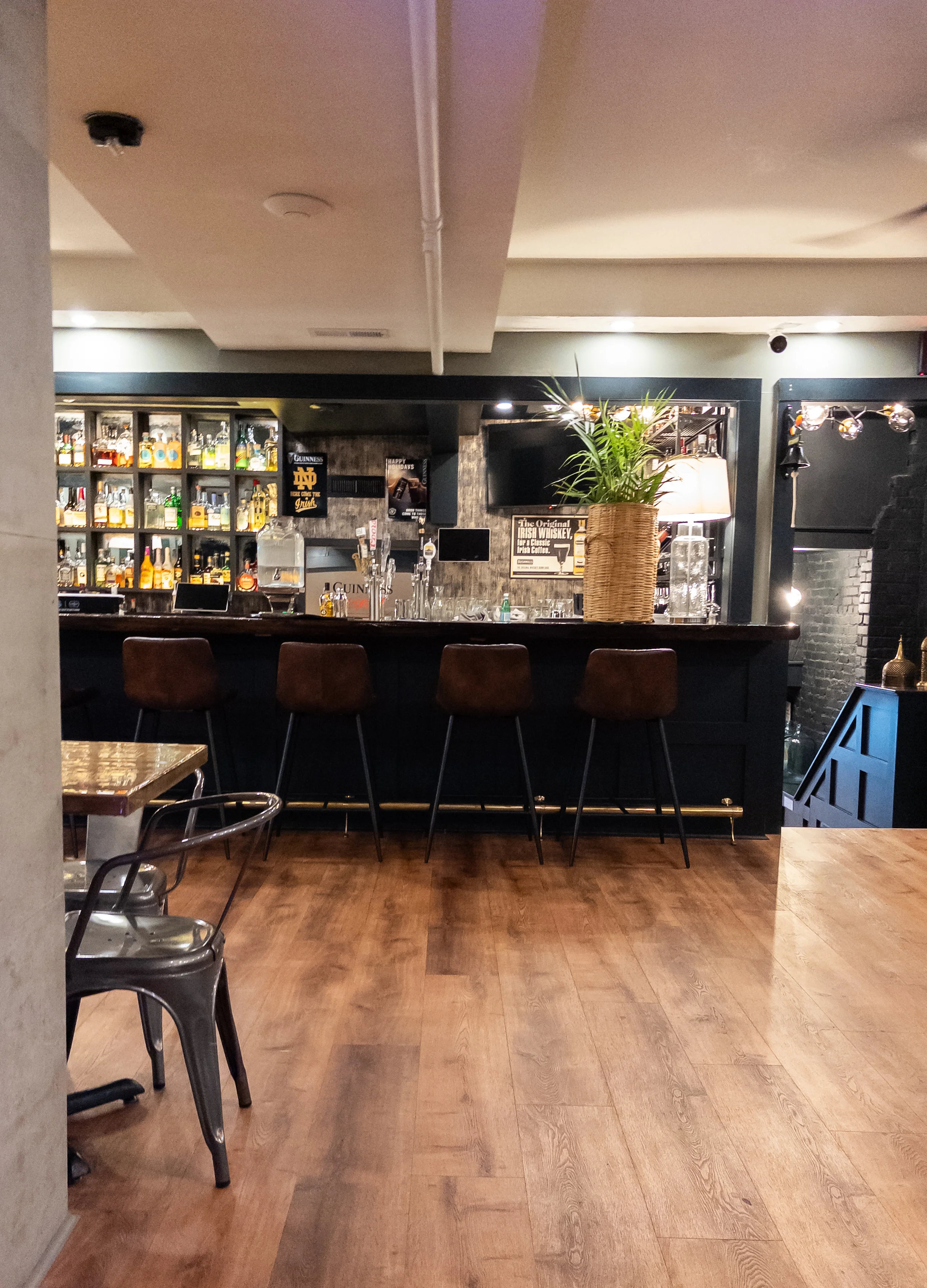 Modern bar interior with stylish seating and shelves of spirits
