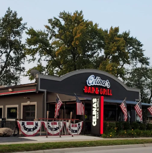 Exterior view of Celina's Bar & Grill with American flags