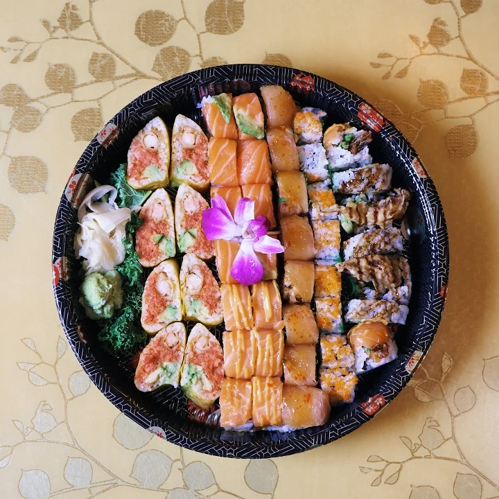  Sushi takeout platter with spicy tuna rolls, salmon rolls and an orchid garnish from Mahzu East Windsor