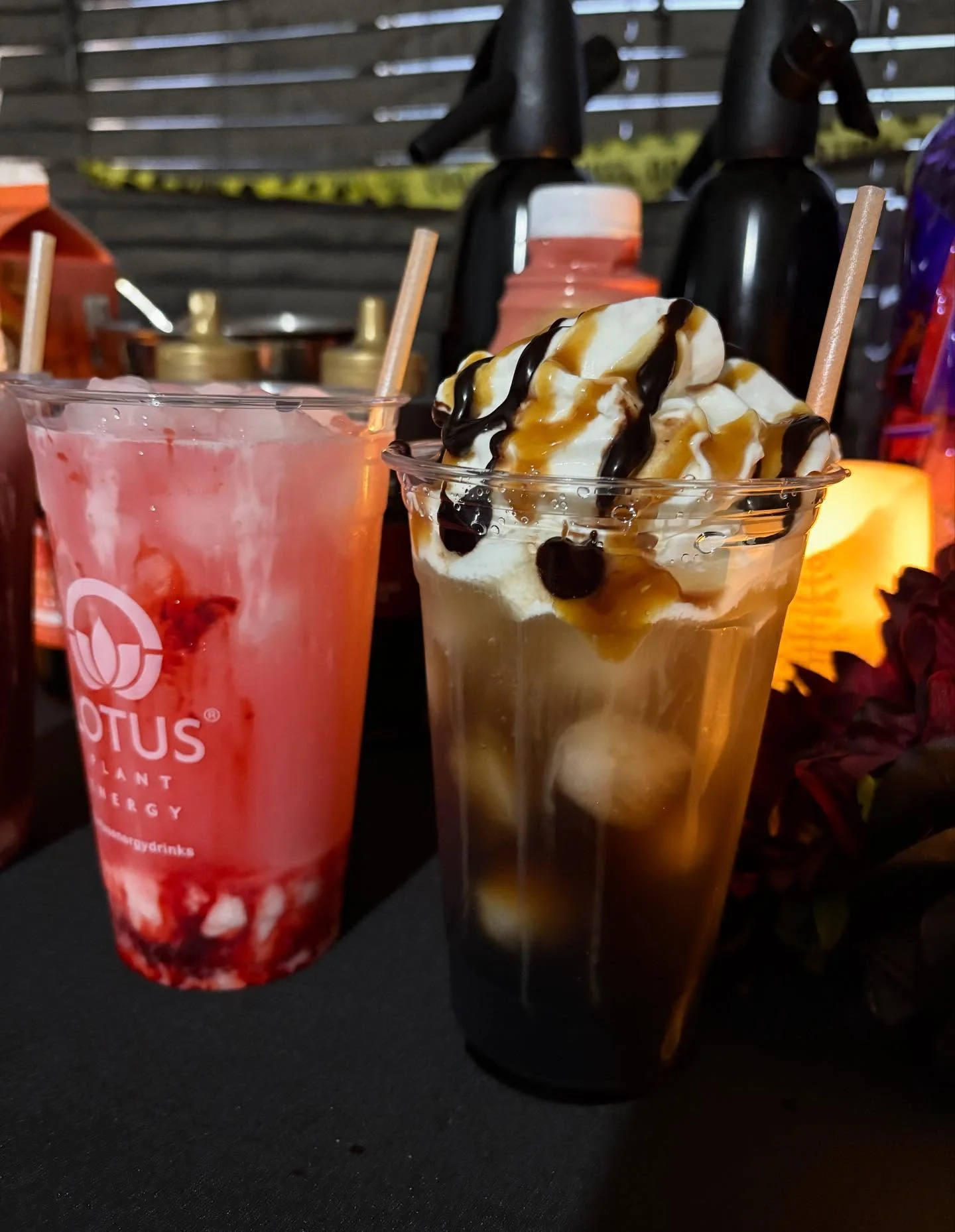 Colorful cocktails with whipped cream and syrup at a vibrant bar