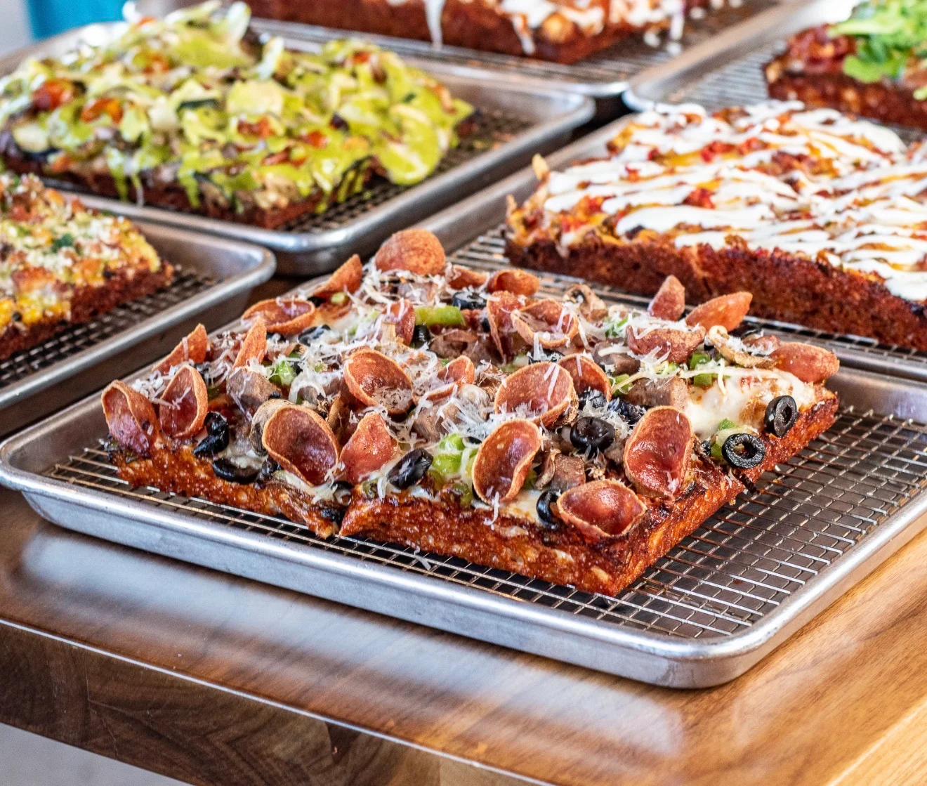 Delicious Detroit-style pizza with pepperoni and olives