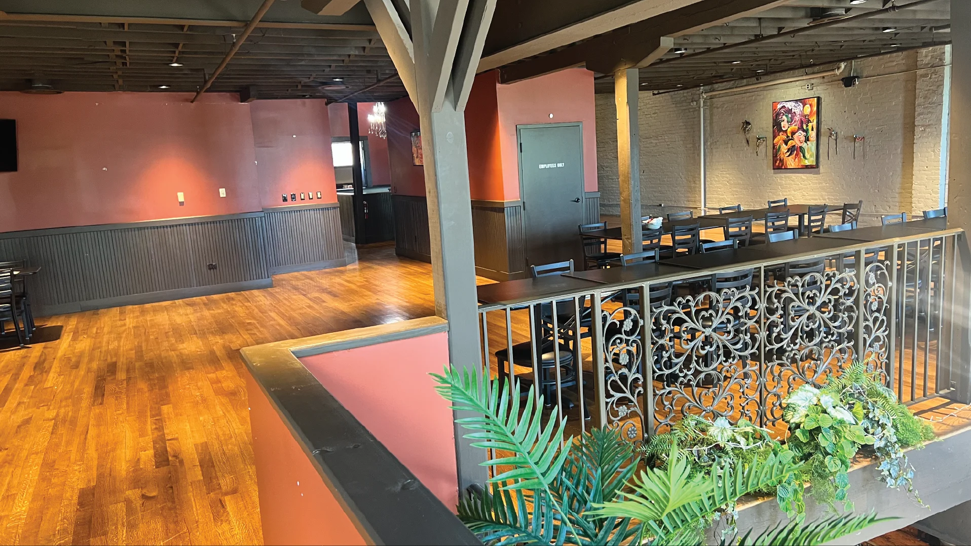 Cozy restaurant interior with wooden floors and decorative railings