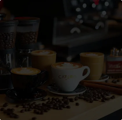 Various coffee drinks with latte art on a wooden table.