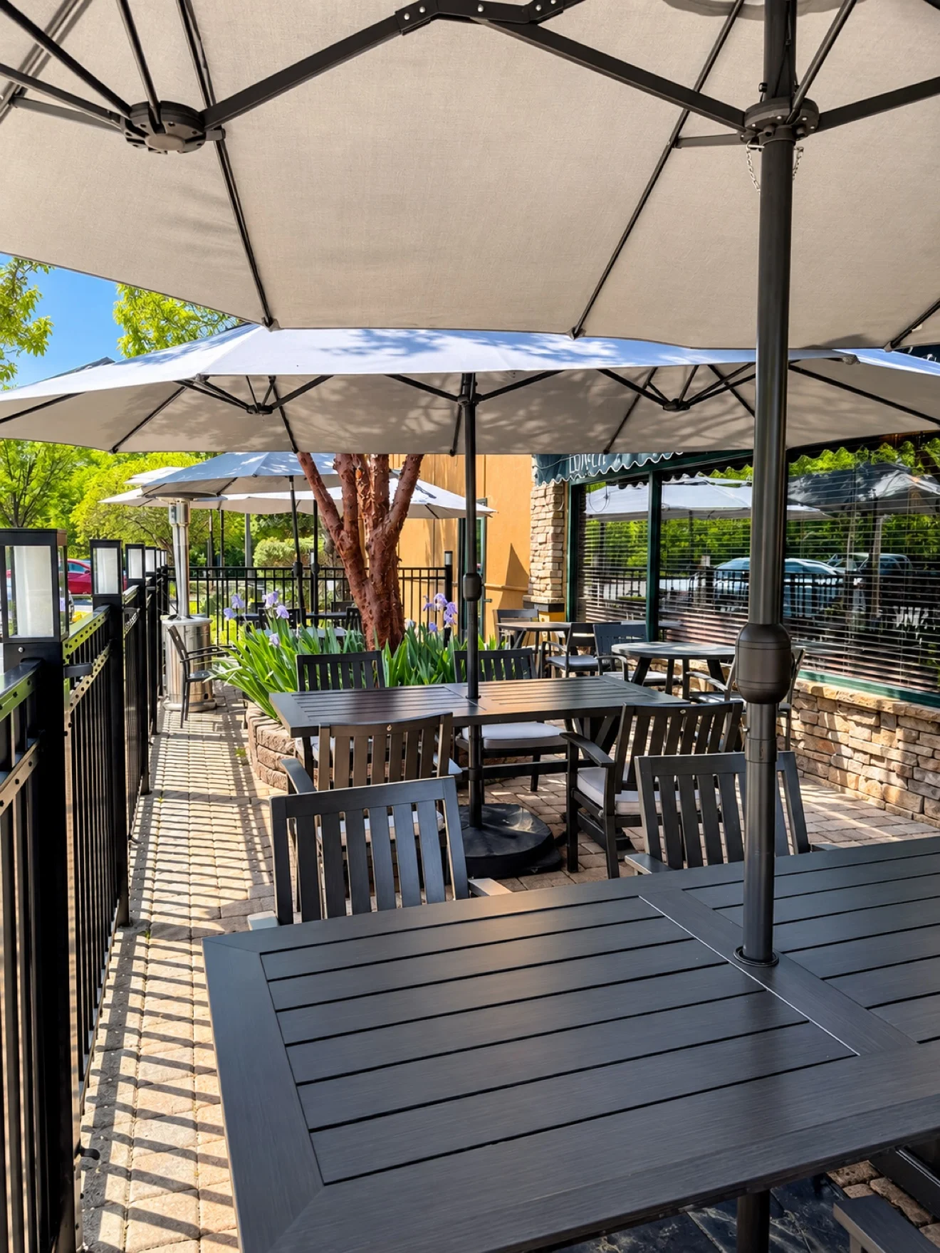 Outdoor patio with tables and umbrellas at Marco's Italian Restaurant in Ashland VA