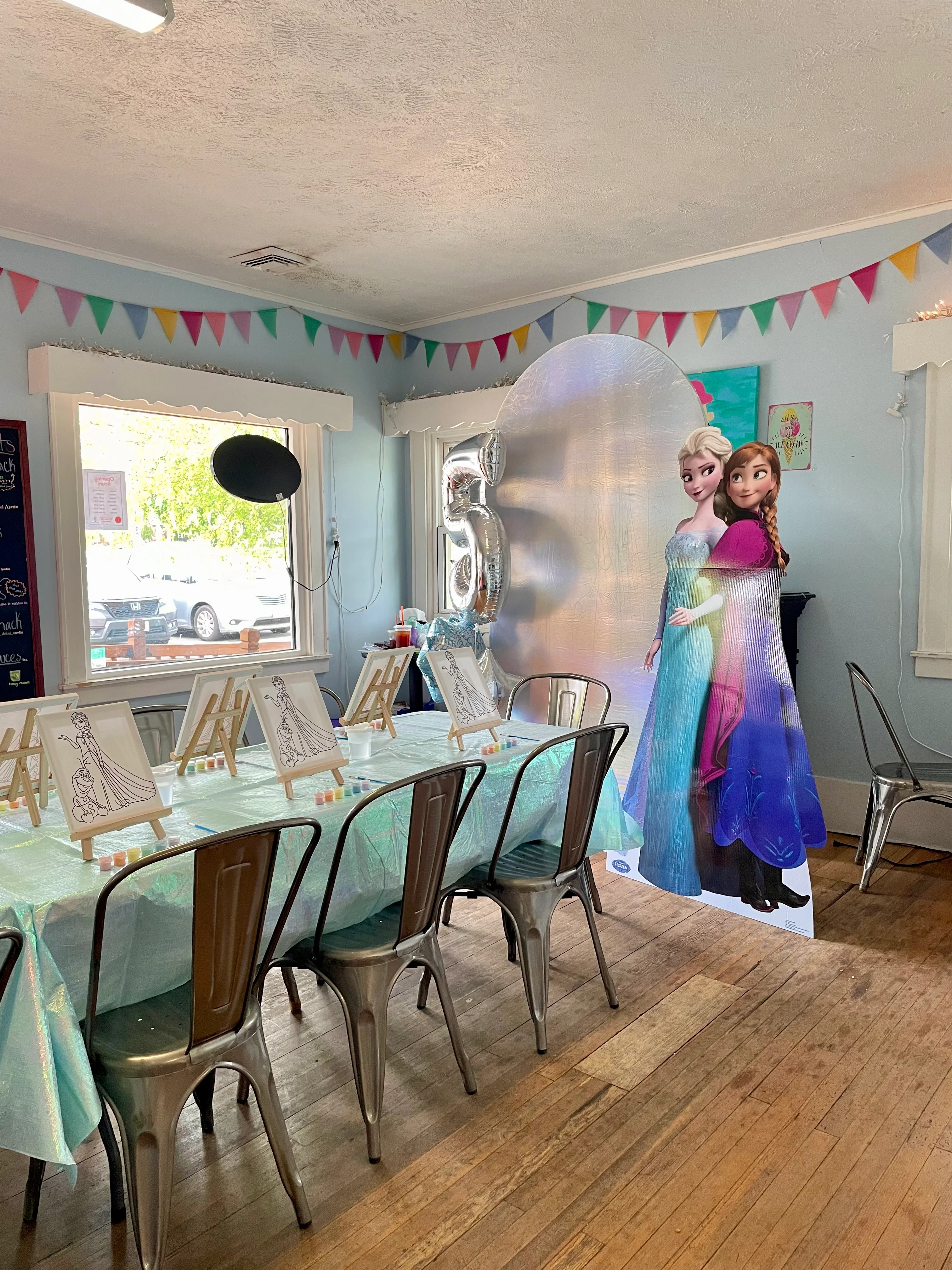 Colorful birthday party setup with Frozen theme decorations