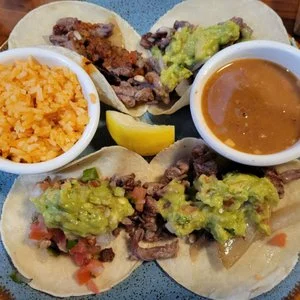 Authentic Mexican tacos with guacamole and rice