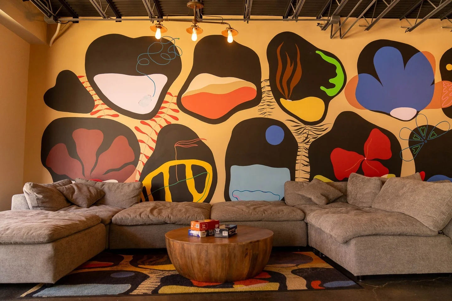 Cozy lounge area with artistic mural and comfortable seating