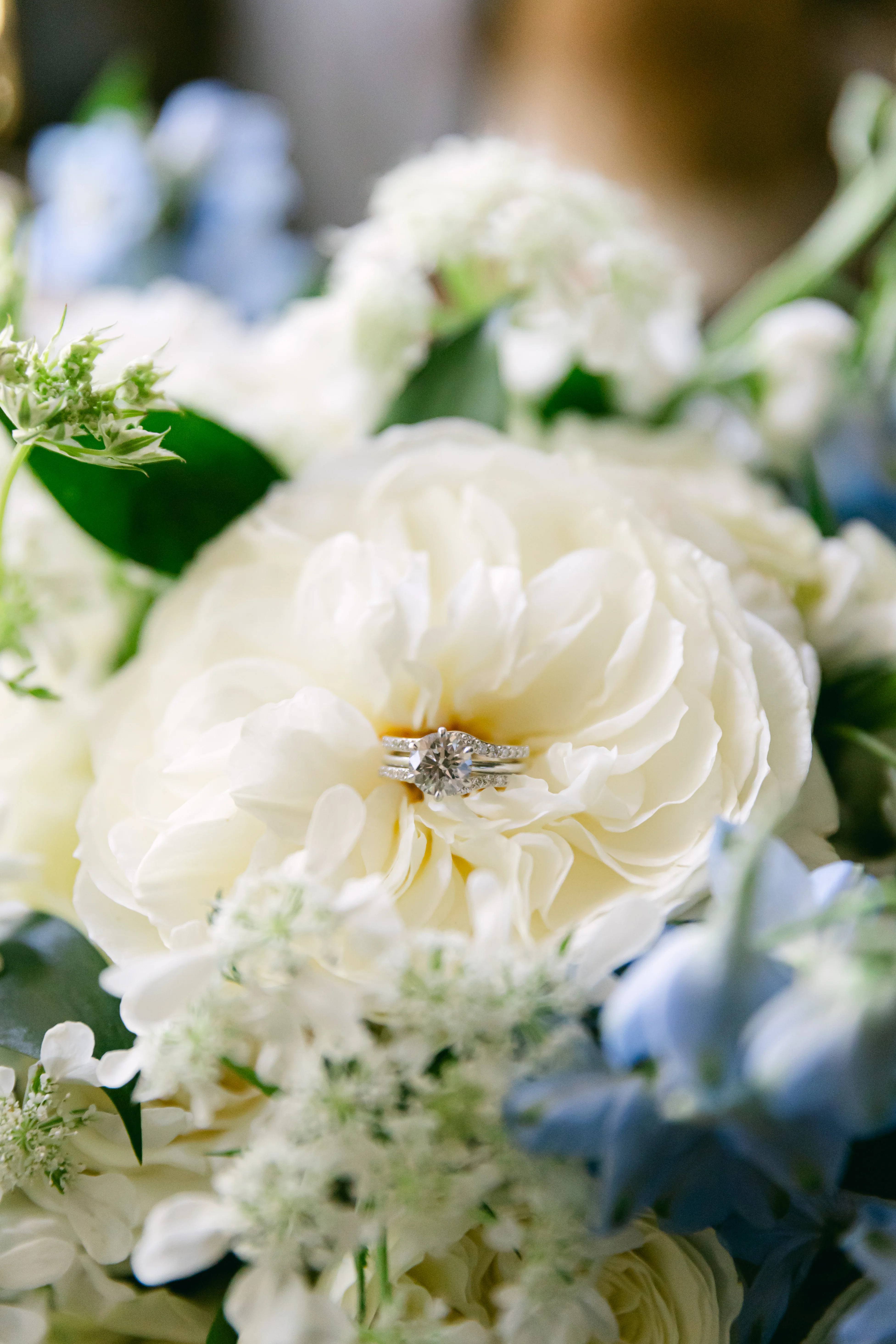Elegant wedding ring nestled in a white peony flower