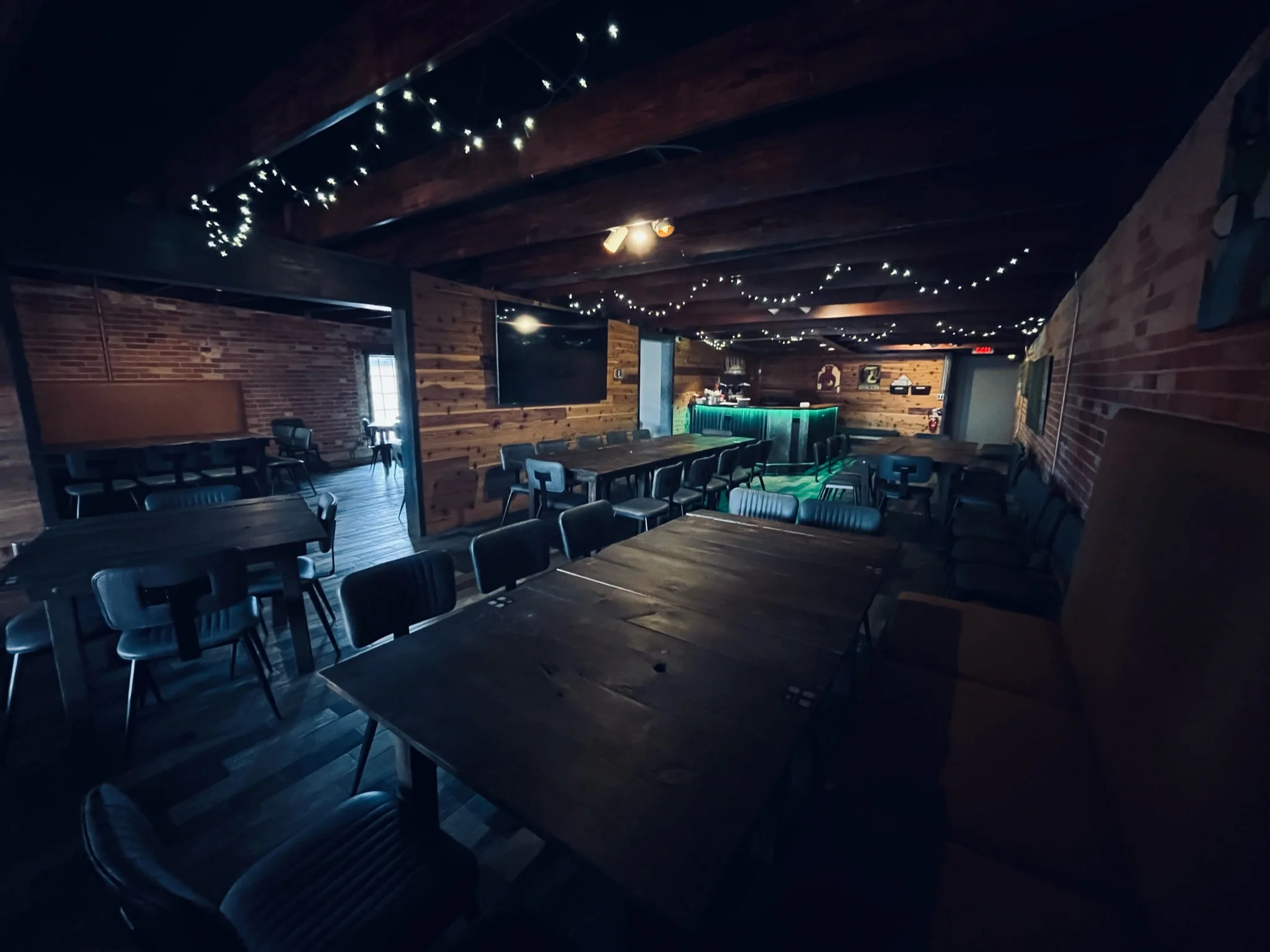 Cozy restaurant interior with rustic wooden beams and warm lighting