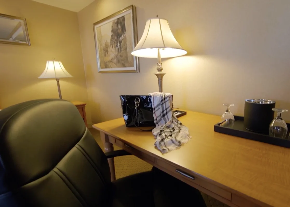 A desk and chair with a lamp in a king room at the Ambassador Hotel Milwaukee