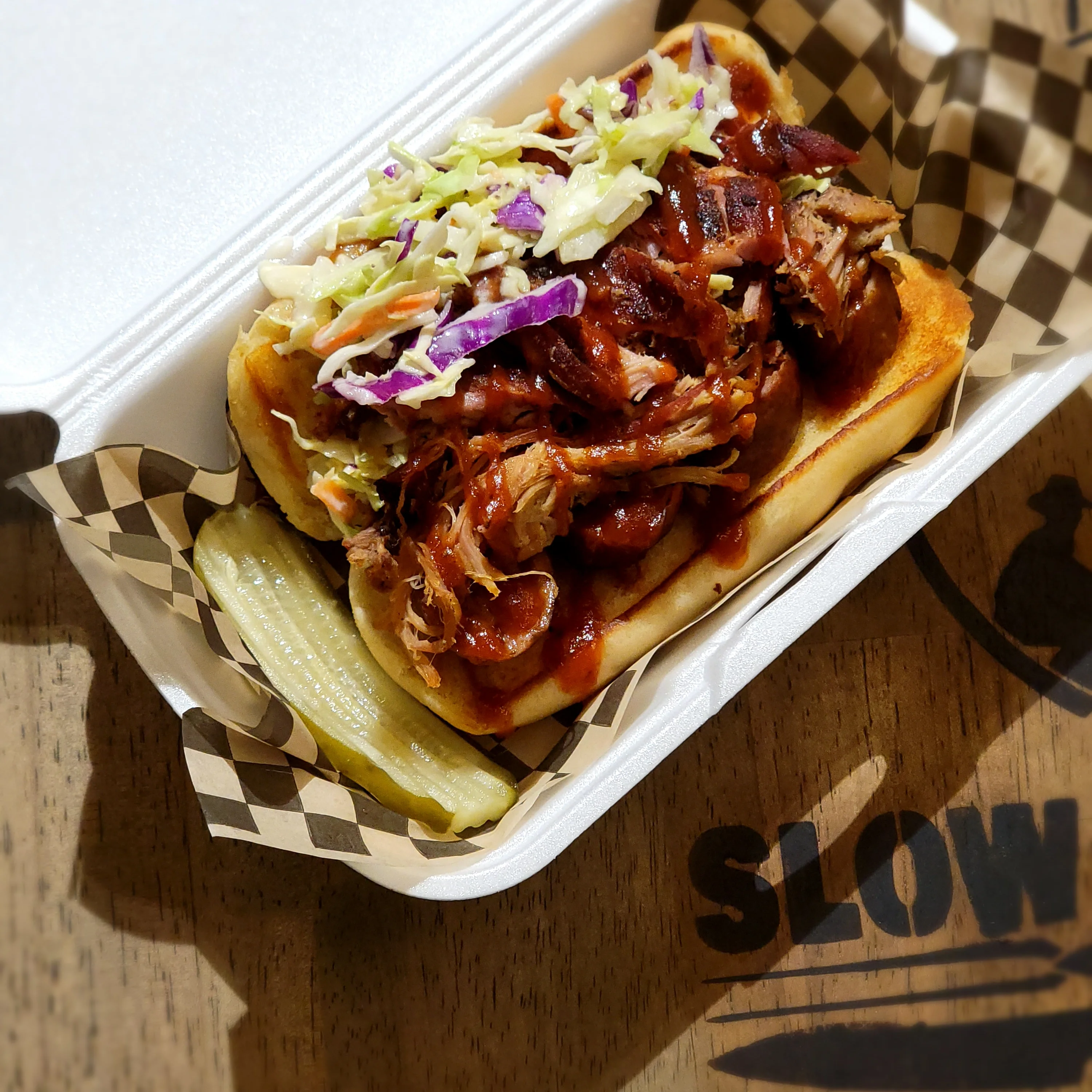 Pulled pork sandwich with coleslaw and pickles