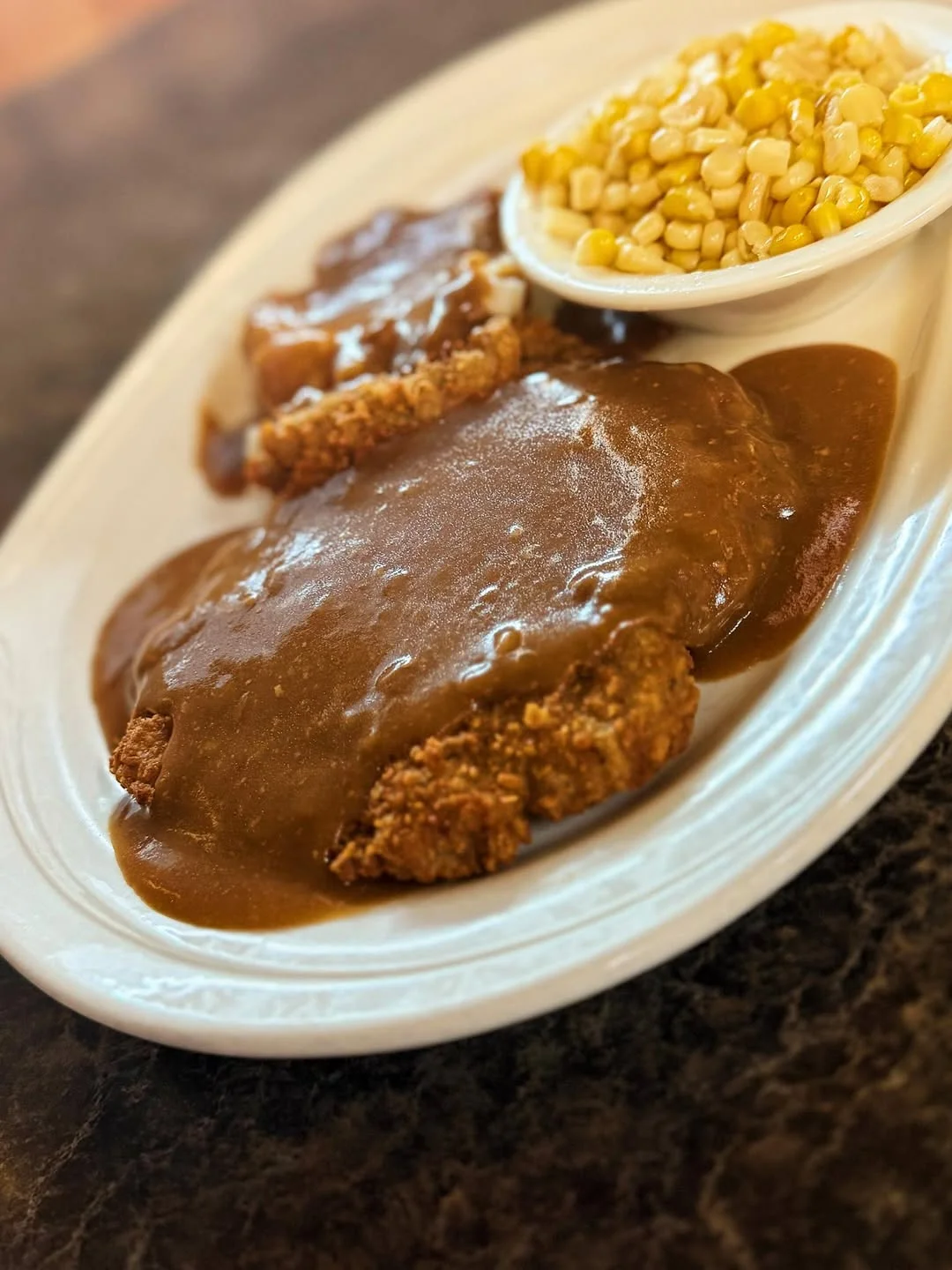 Southern chicken fried steak with gravy and corn