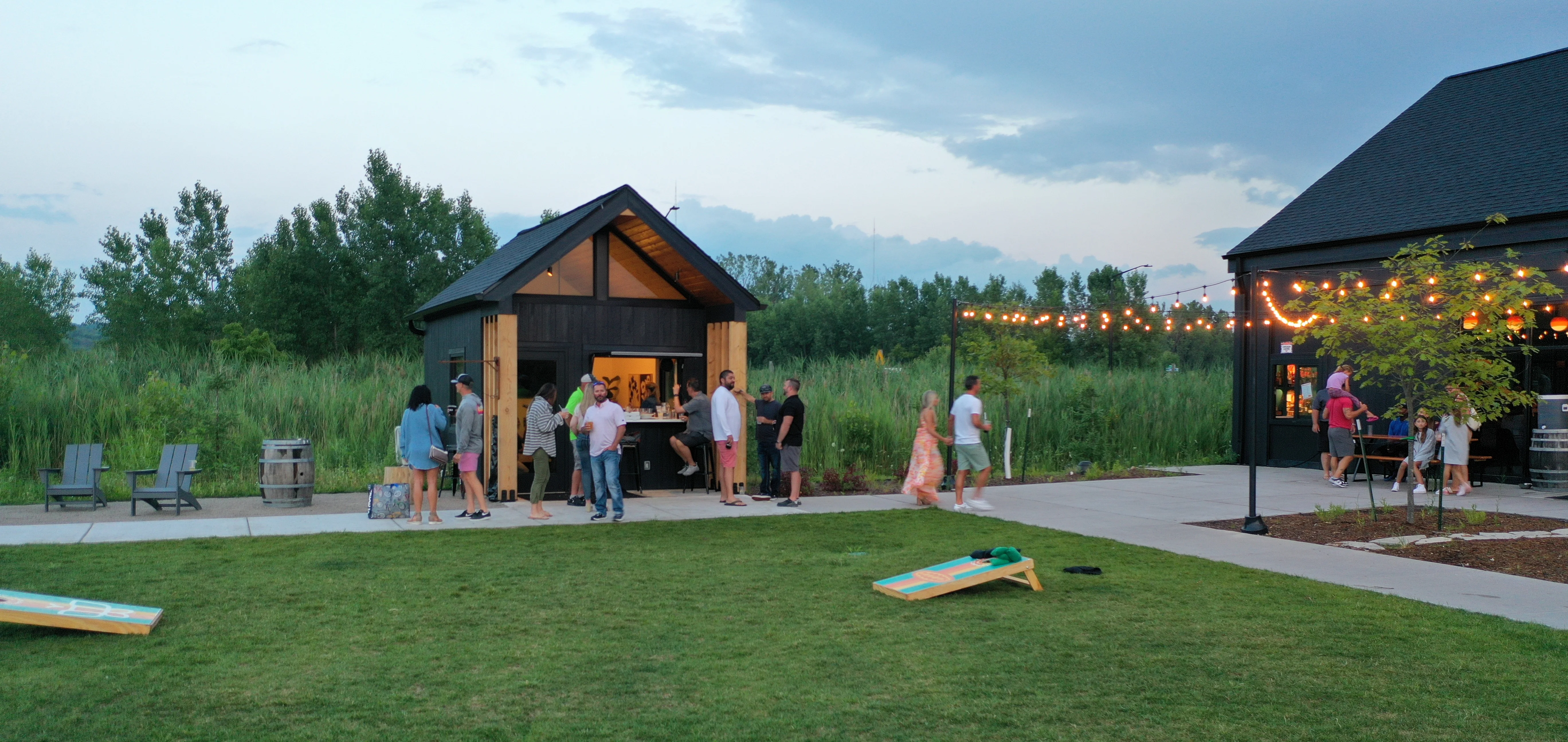 Outdoor gathering space with string lights and food vendors