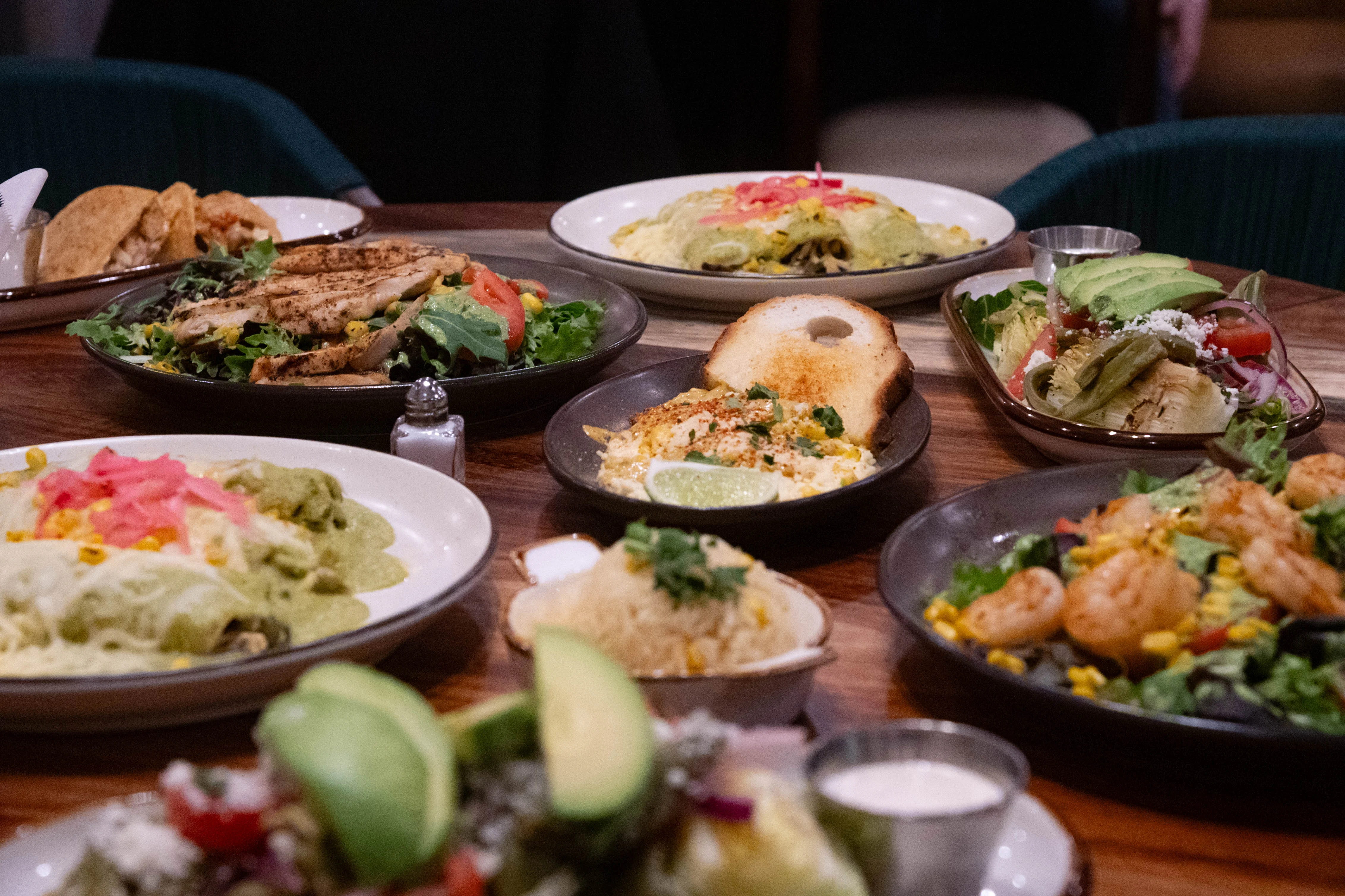 Colorful Mexican feast featuring tacos and shrimp salad