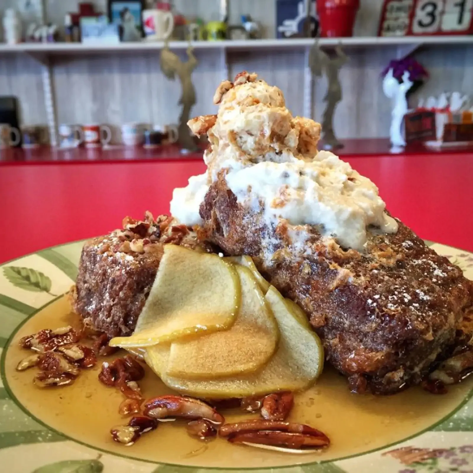 Plated dessert with ice cream, poached pears, whipped cream, and pecans