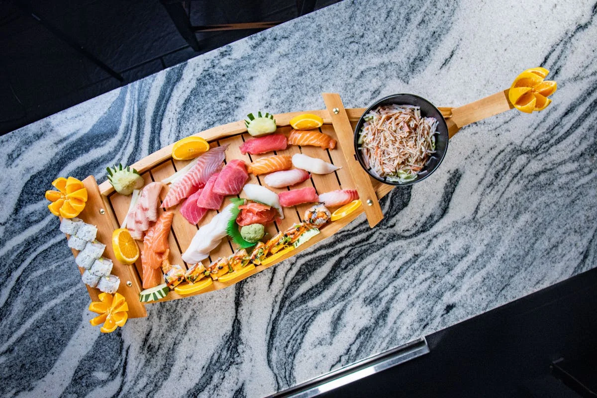 Sushi boat platter featuring assorted nigiri and rolls