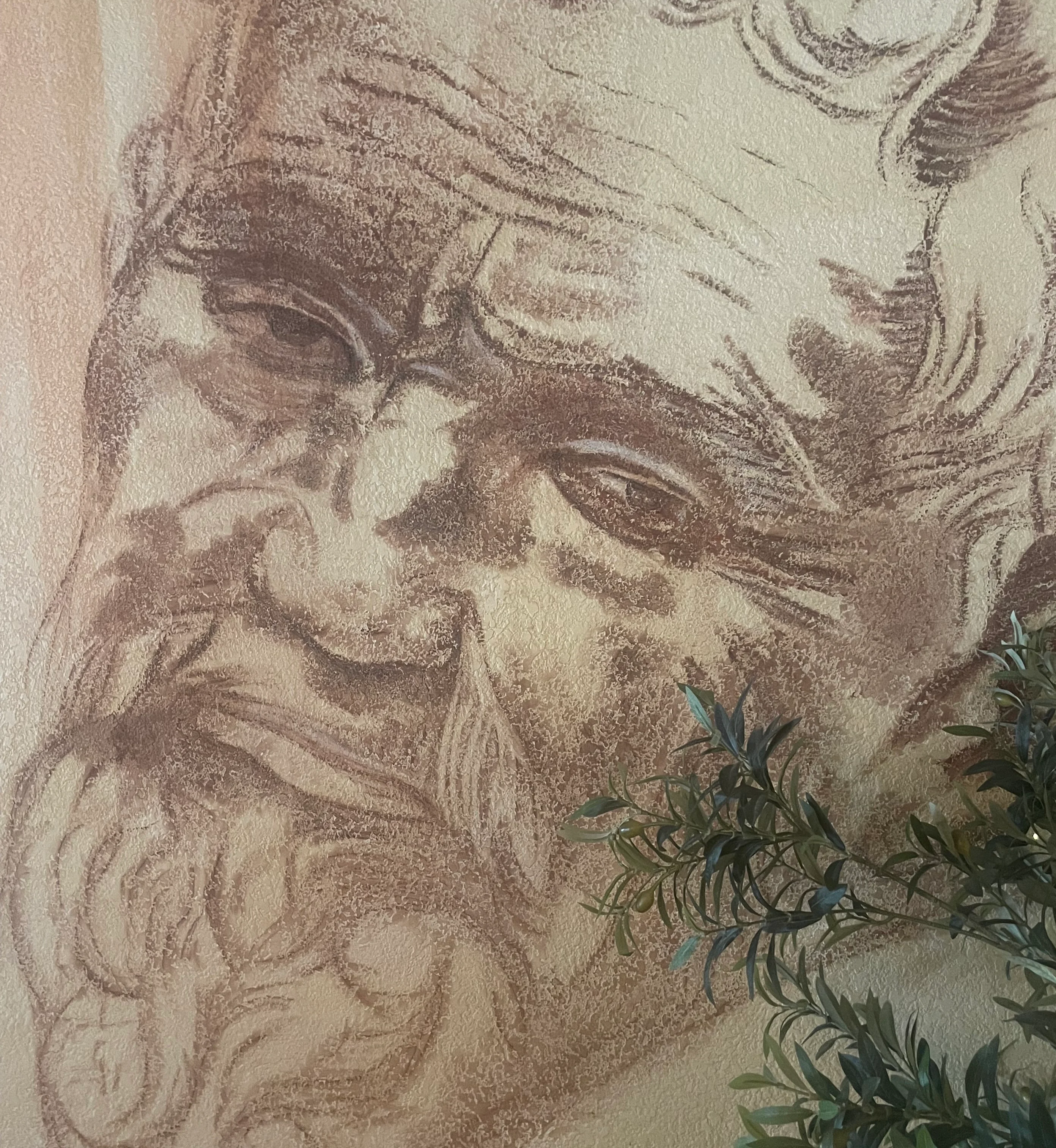 Artistic wall mural of an elderly man's face