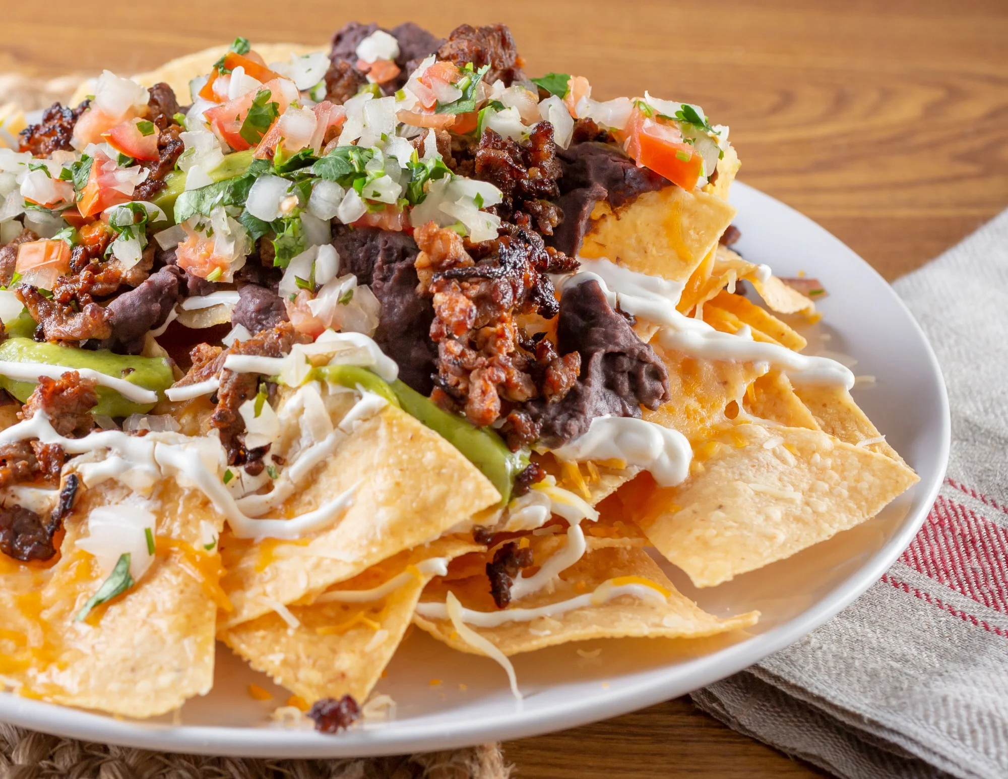 Loaded nachos topped with meat and fresh toppings