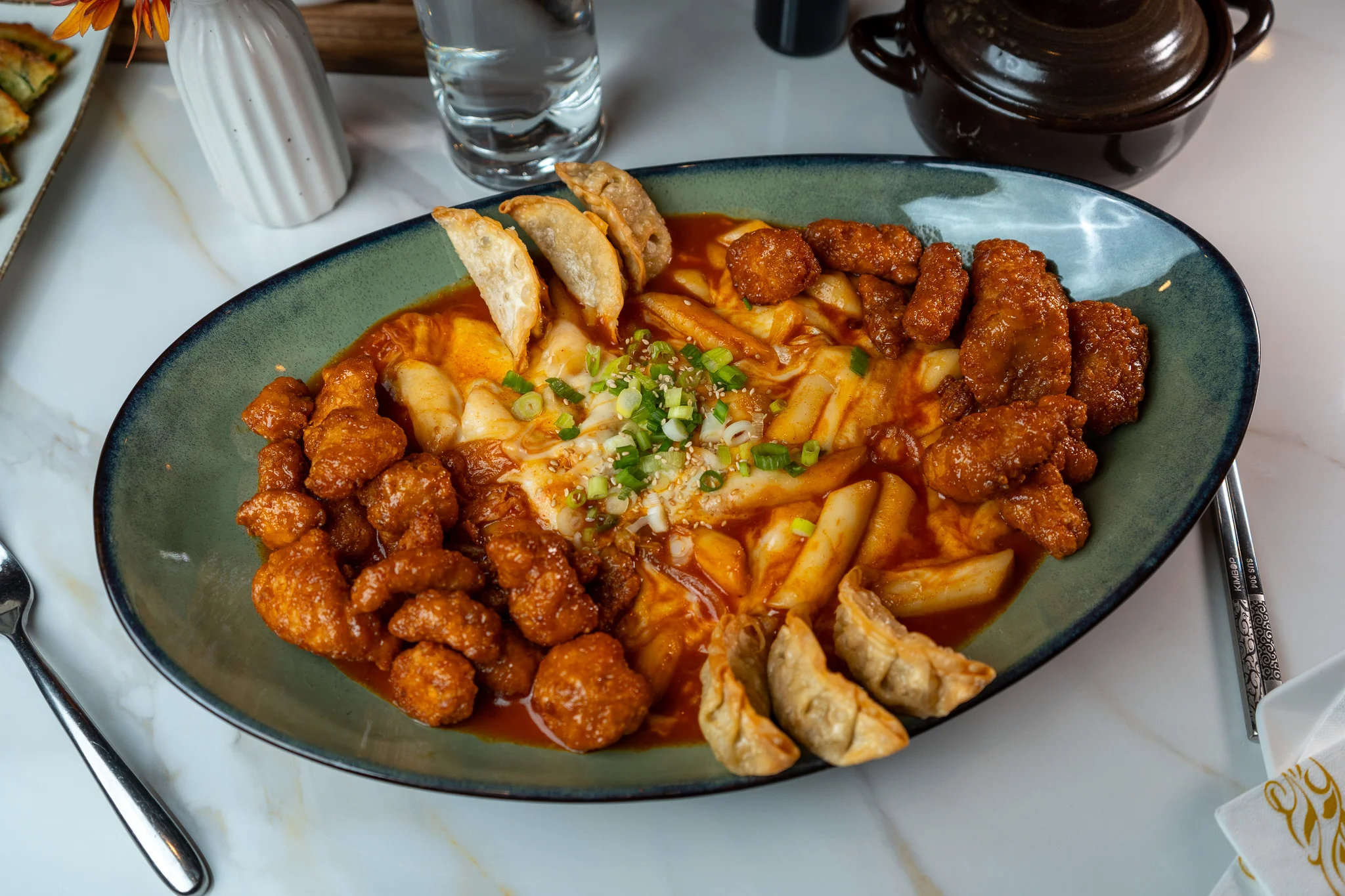 Korean tteokbokki with fried chicken and dumplings