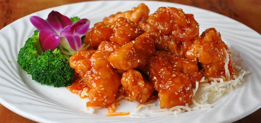 Sweet and sour chicken served with broccoli