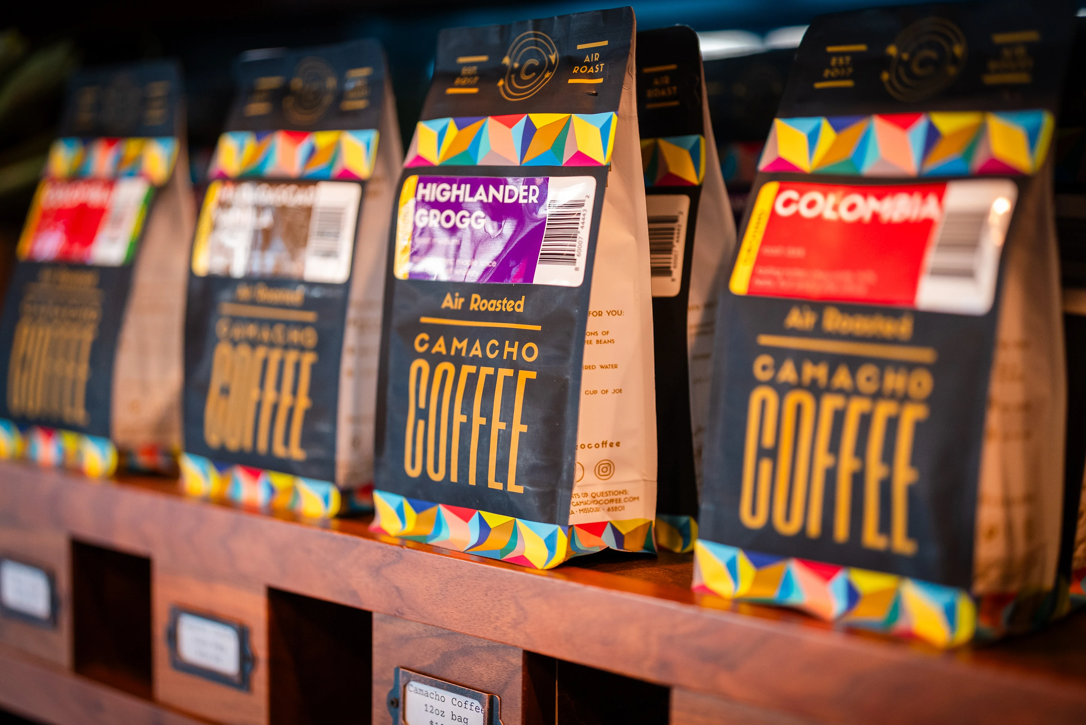 Packages of Camacho Coffee lined up on shelves