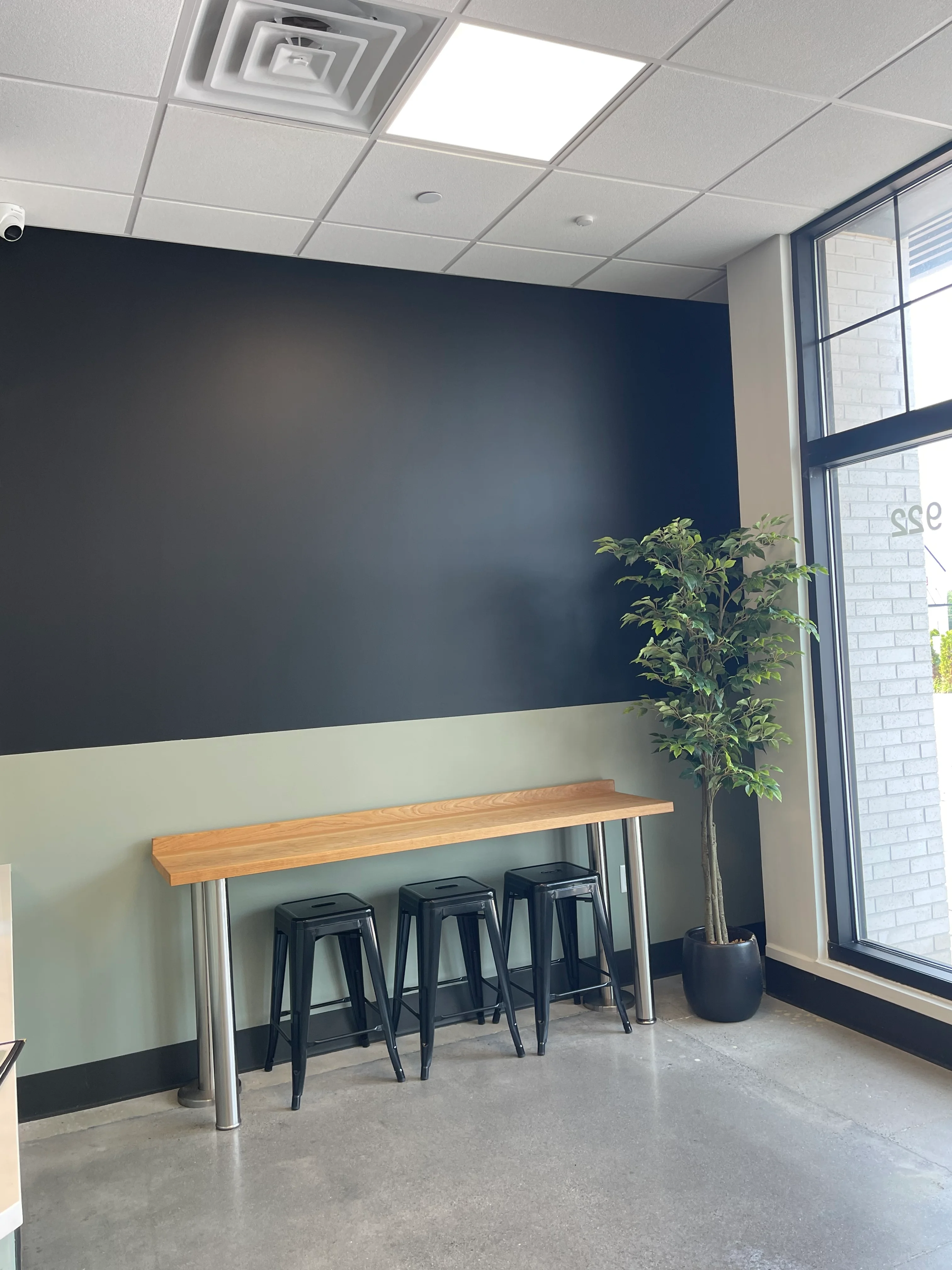 Modern restaurant interior with framed decor and greenery