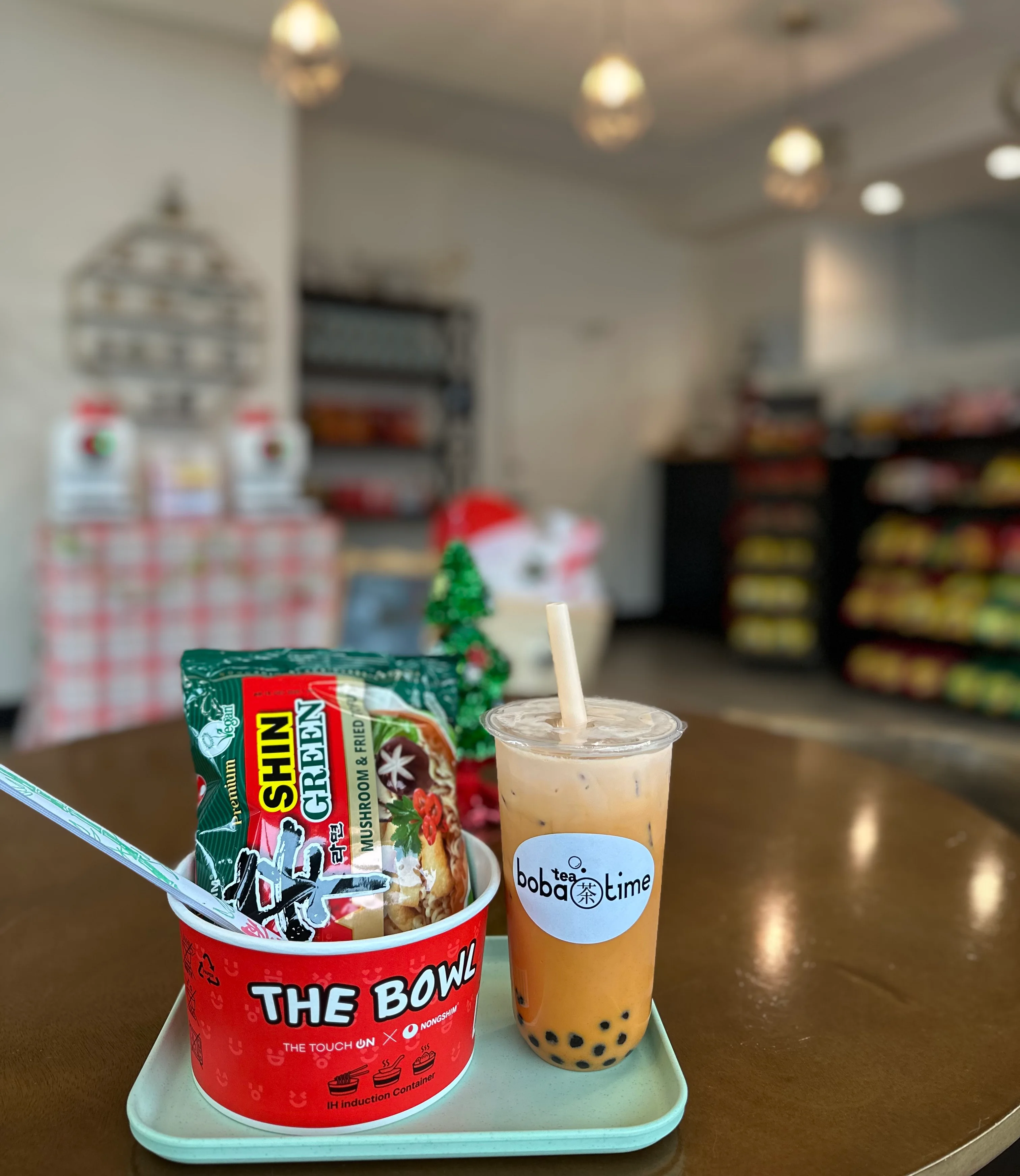 Korean Shin Ramyeon noodles with boba tea in a cozy cafe setting
