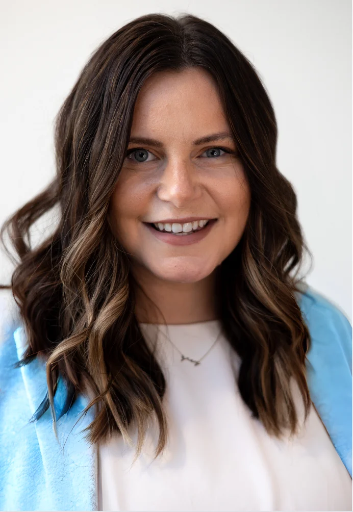 Professional portrait of a smiling woman with wavy hair