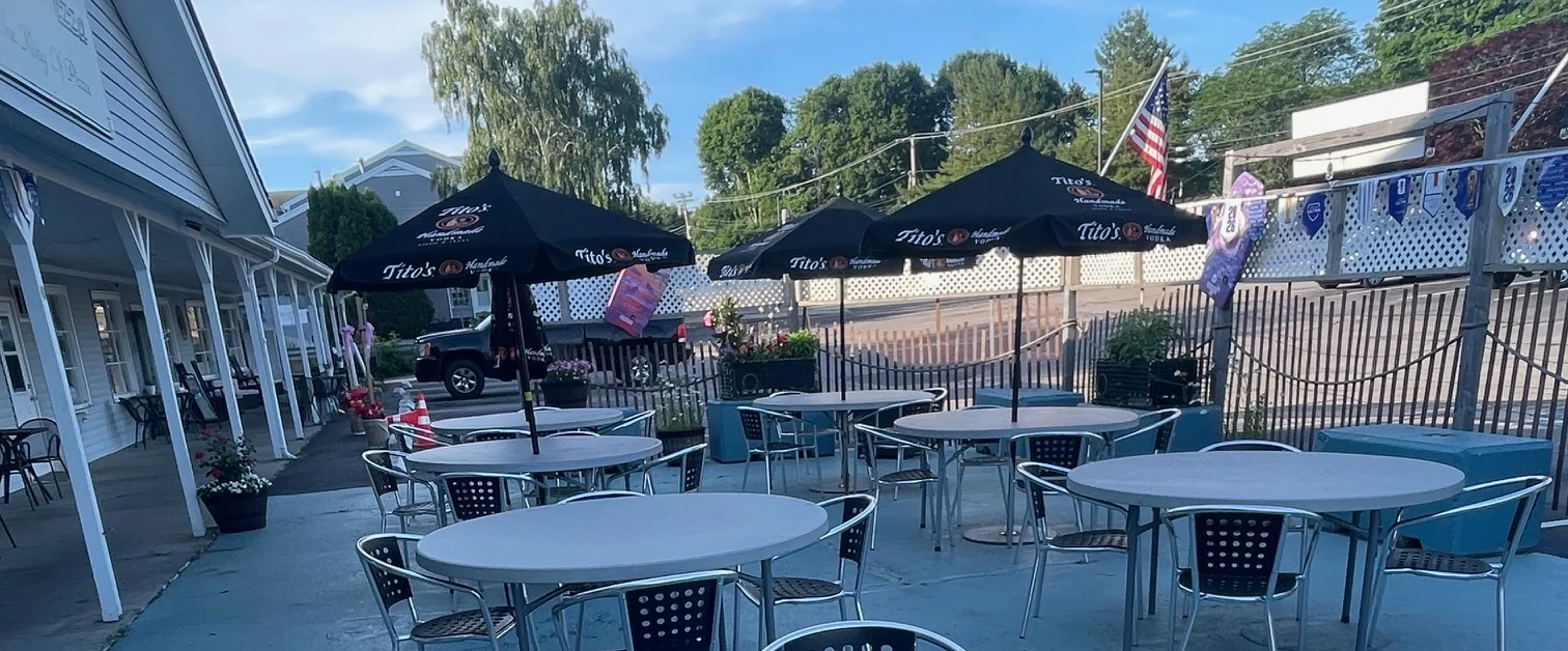 Outdoor dining area with tables and umbrellas