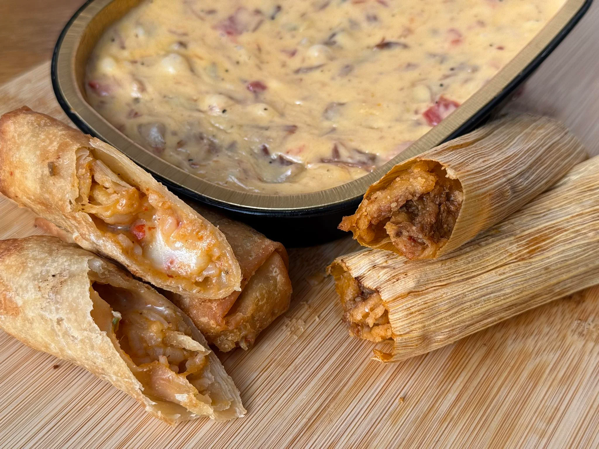 Crispy egg rolls with queso dip and tamales