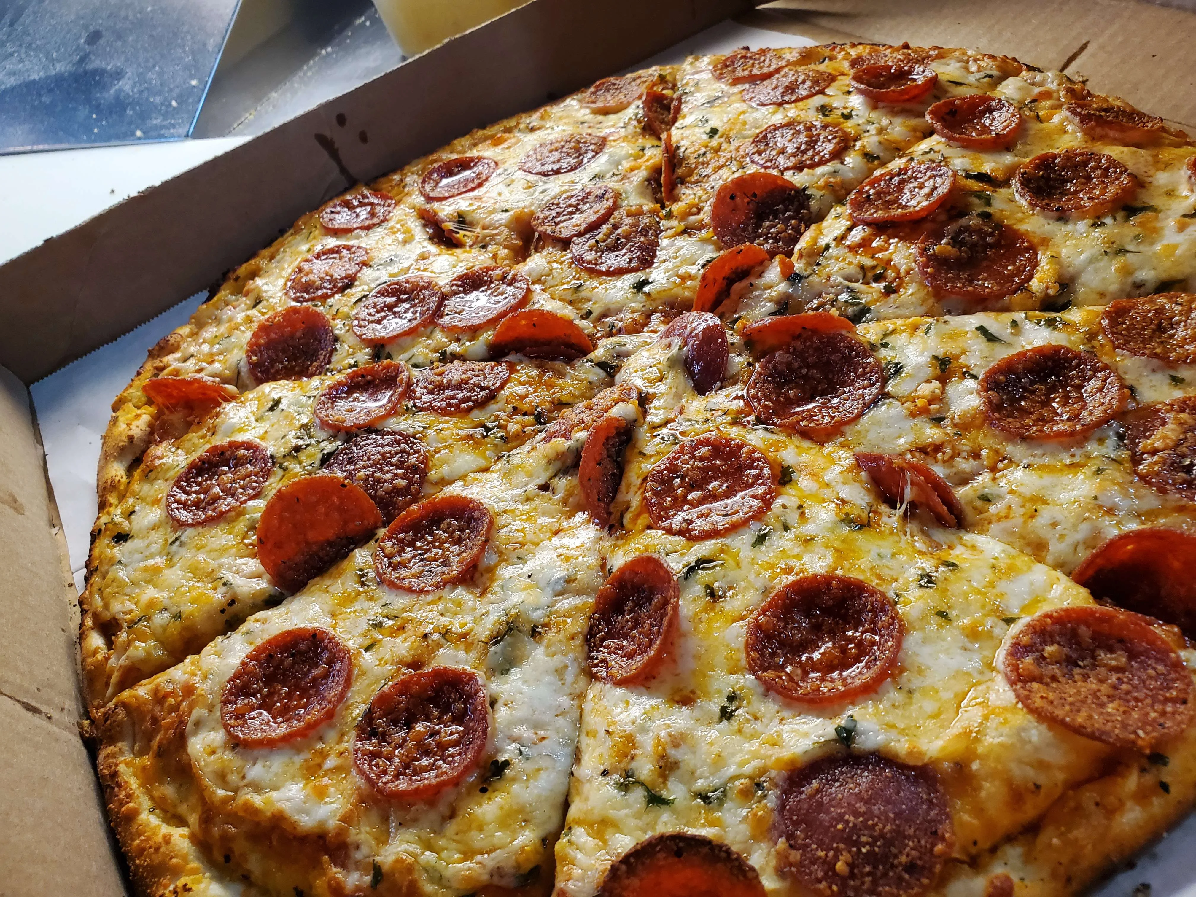 Pepperoni pizza in a pizza box, a classic Italian-American dish