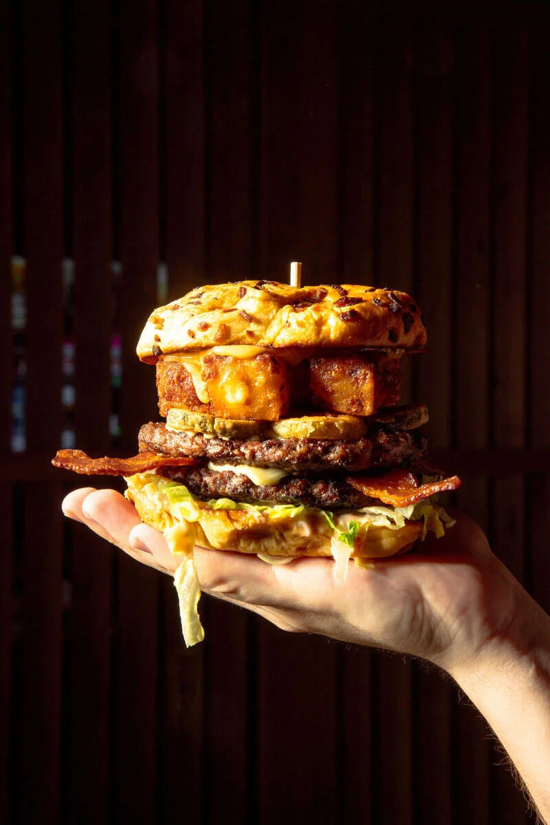 Delicious gourmet burger with fresh toppings on a wooden table