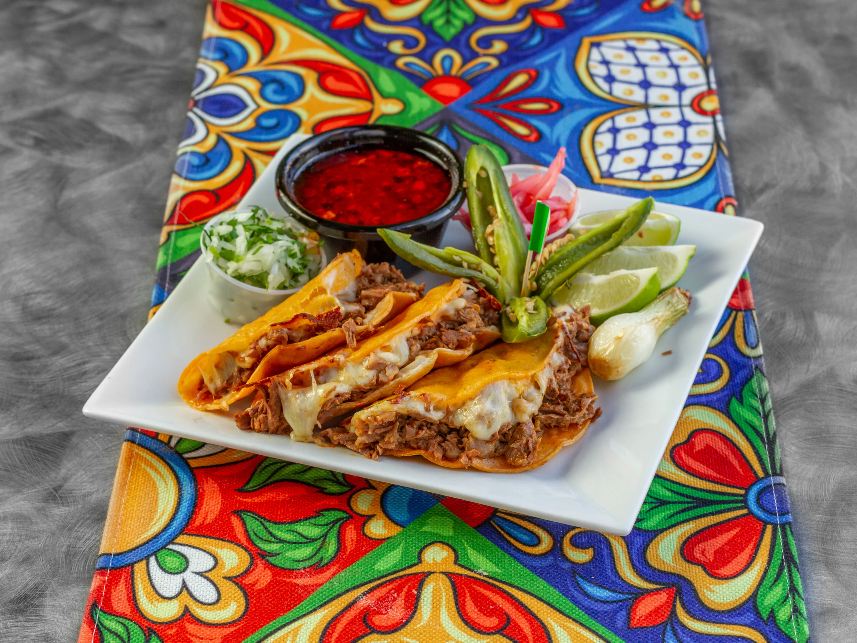 Delicious Mexican tacos de barbacoa with cheese and fresh toppings