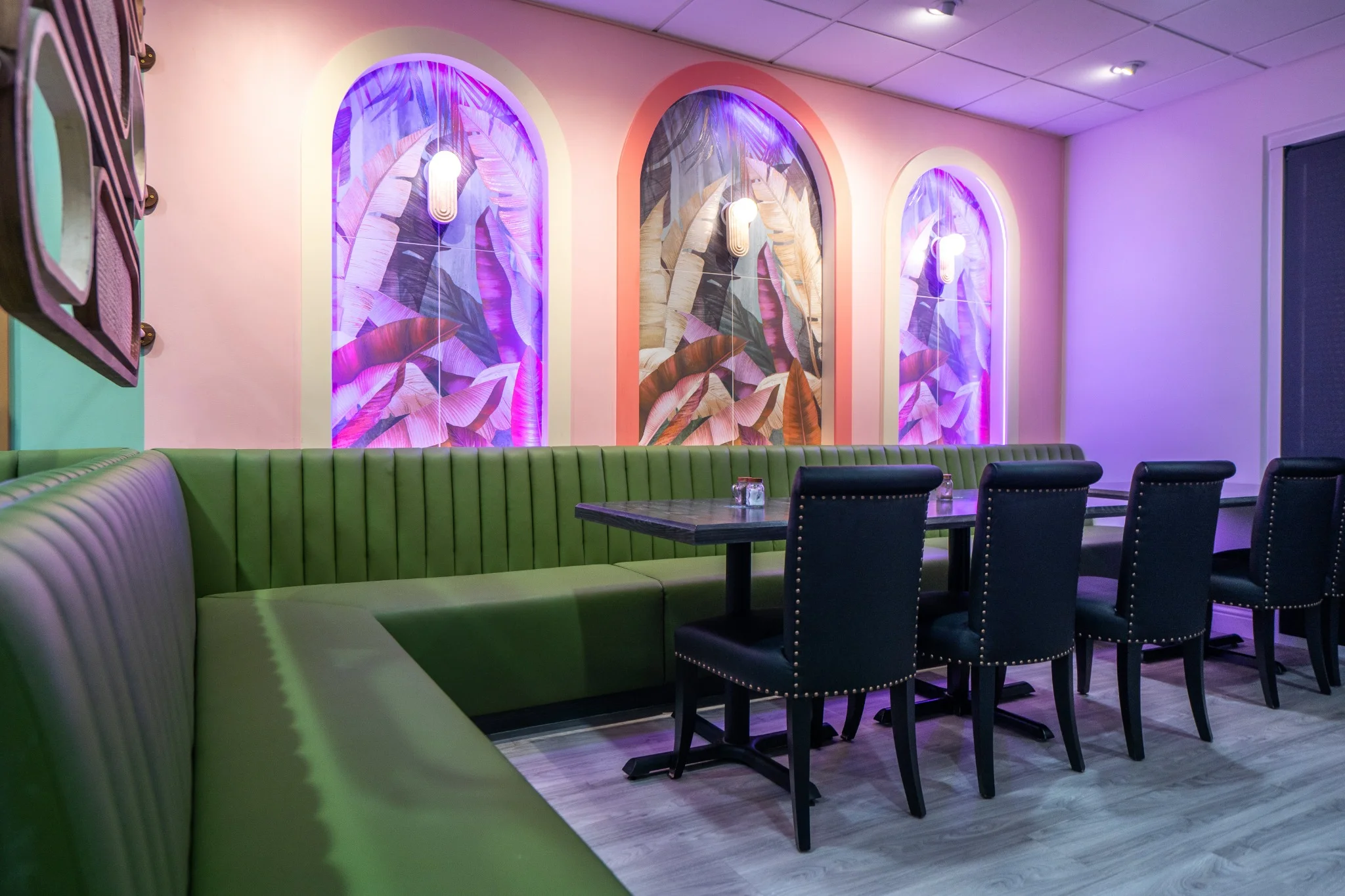 Cozy restaurant interior featuring booth seating and warm lighting.