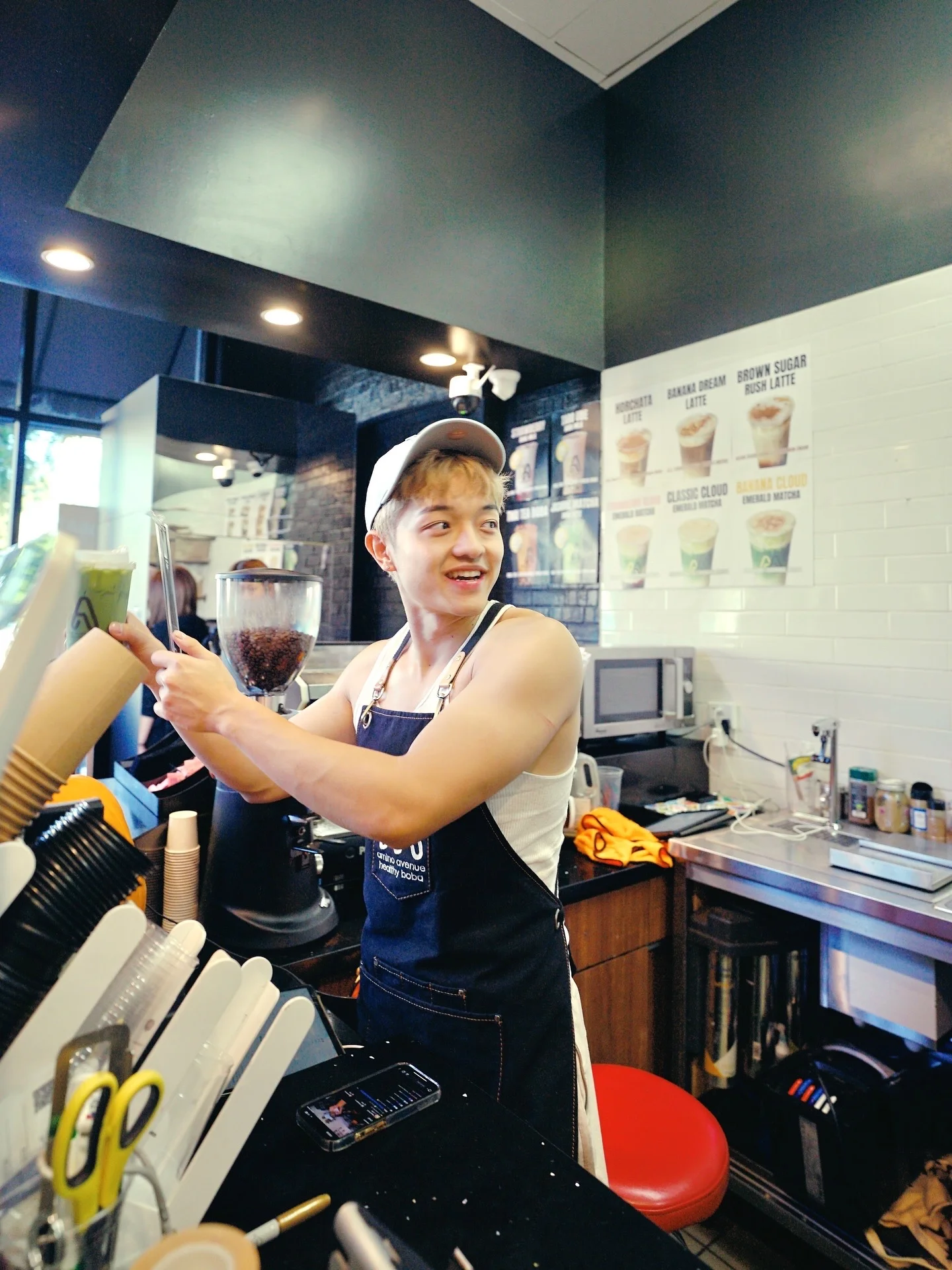 Barista preparing drinks at a modern café counter