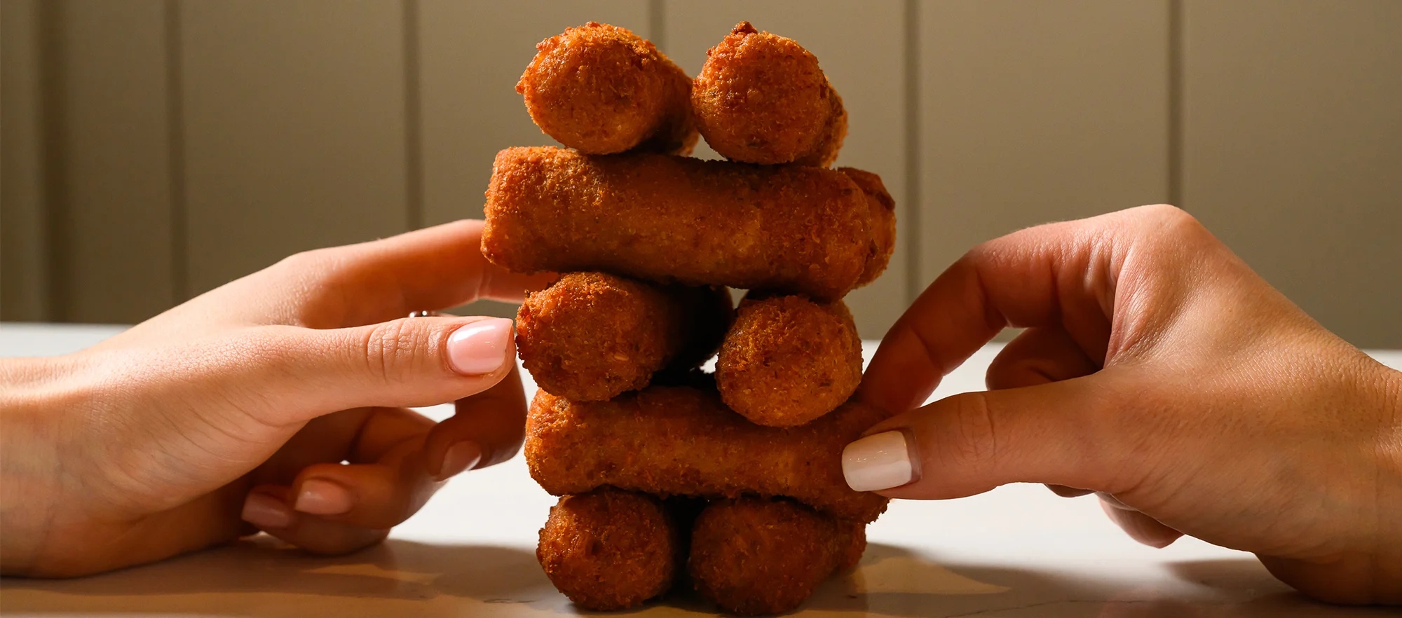 Crispy croquettes stacked on a table