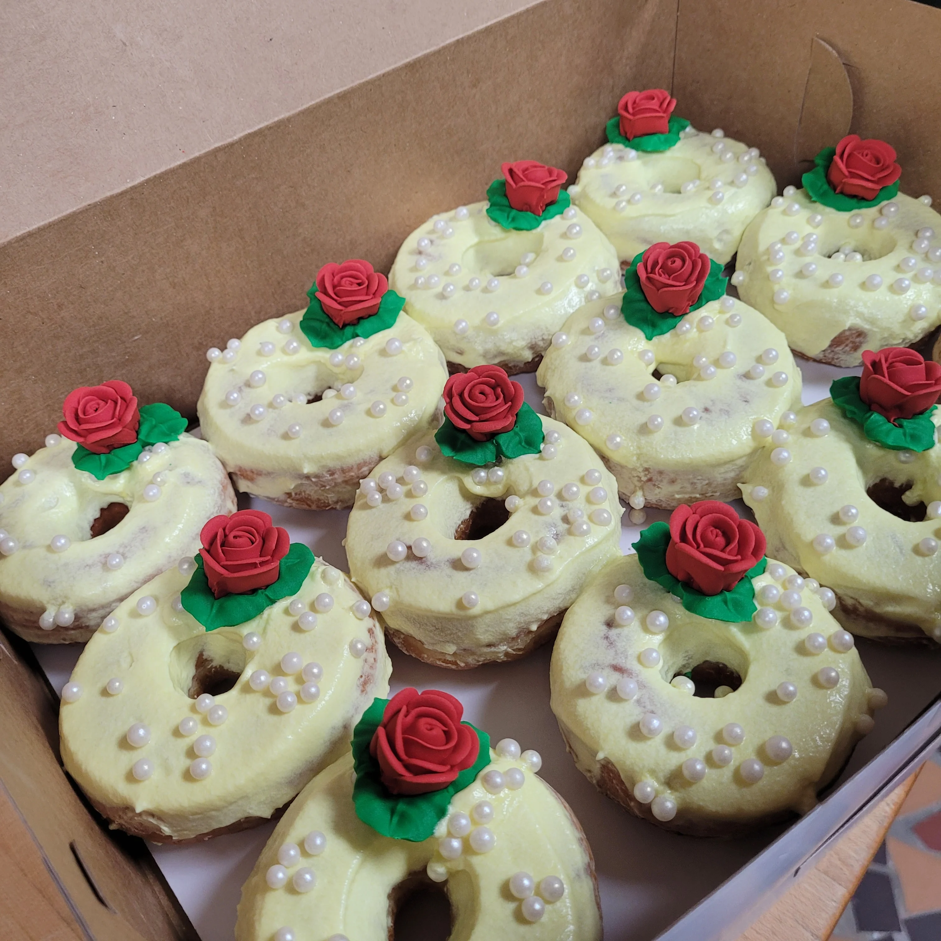 Decorative donuts with rose icing and pearl sprinkles