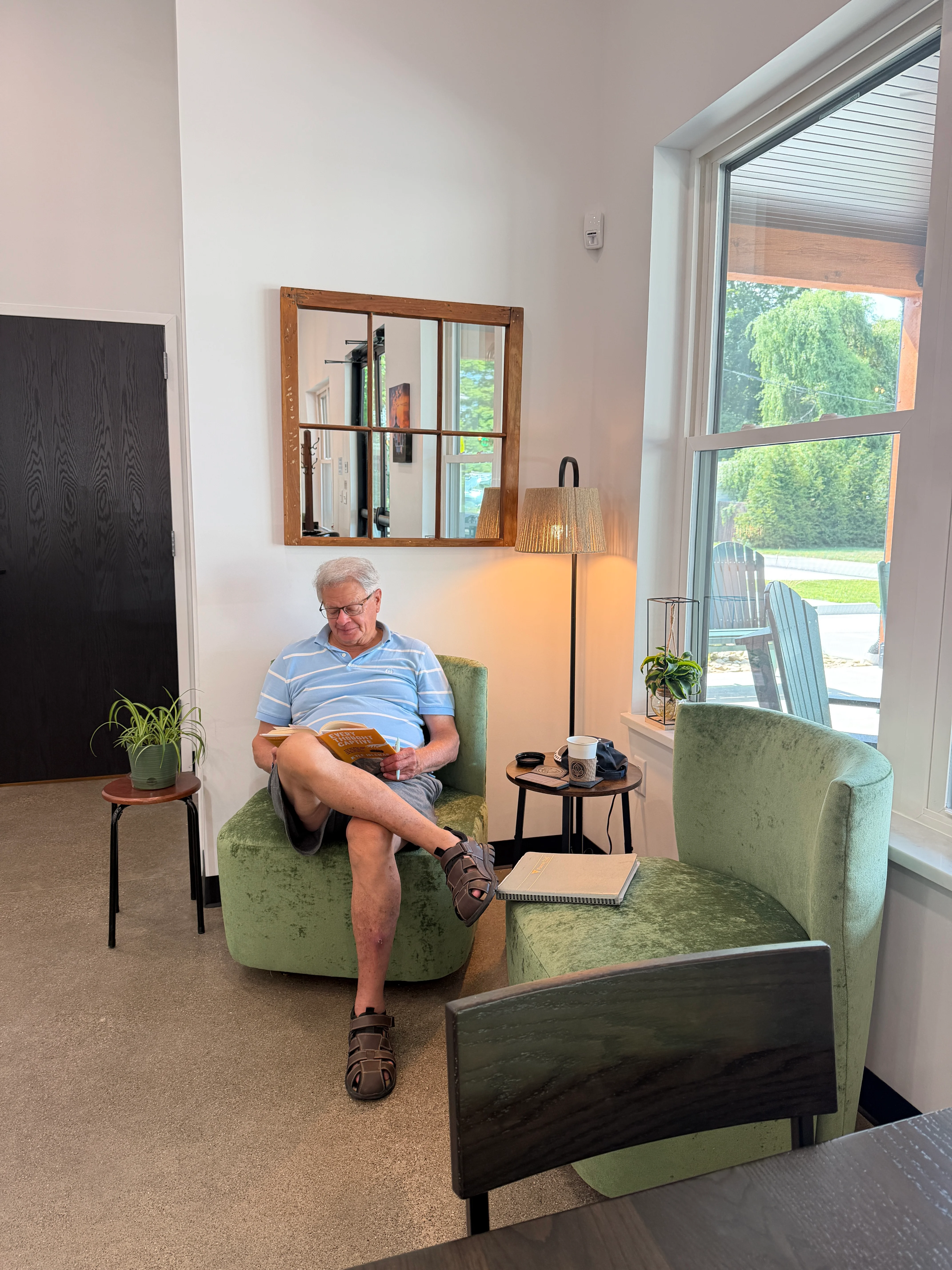 Cozy reading nook with a man relaxing in a modern interior space