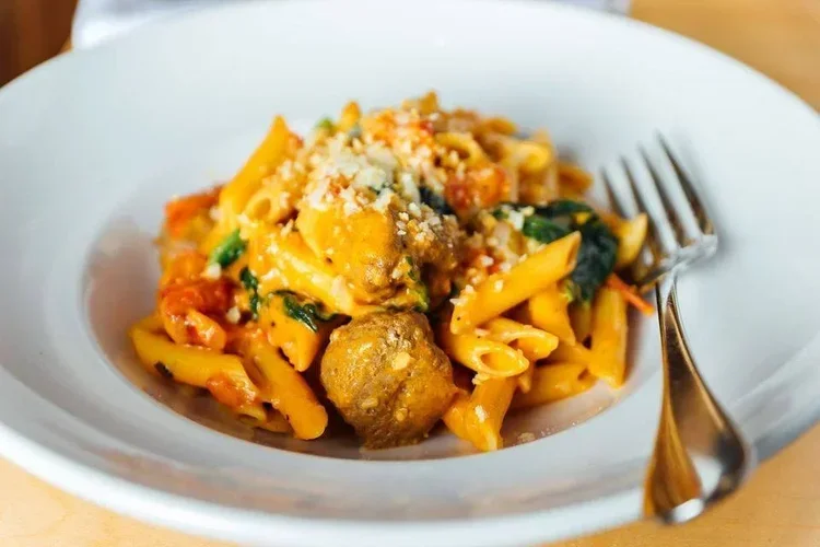 Penne pasta with meatballs in a rich tomato sauce