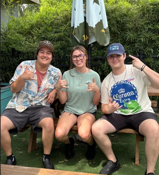 Group of friends enjoying a sunny day at a casual outdoor restaurant