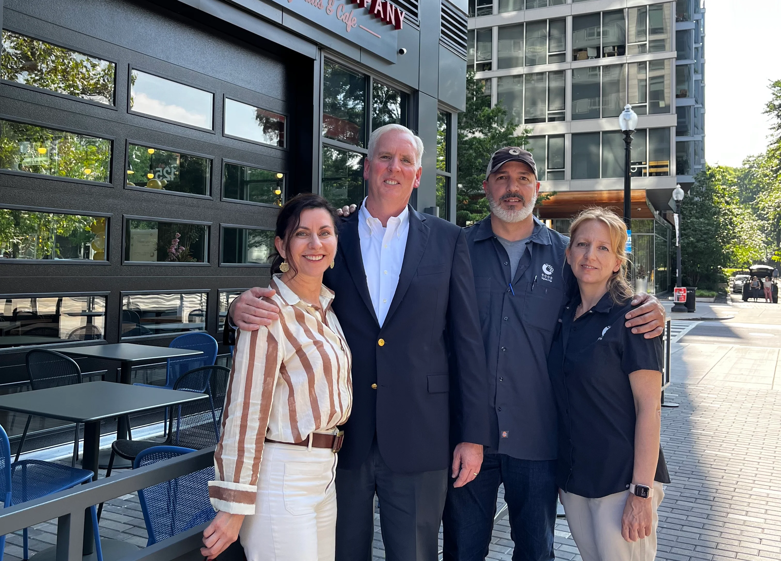Group of restaurant team members outside a modern café