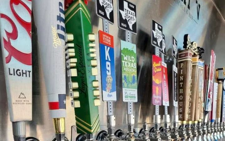 Variety of craft beer taps at a modern bar